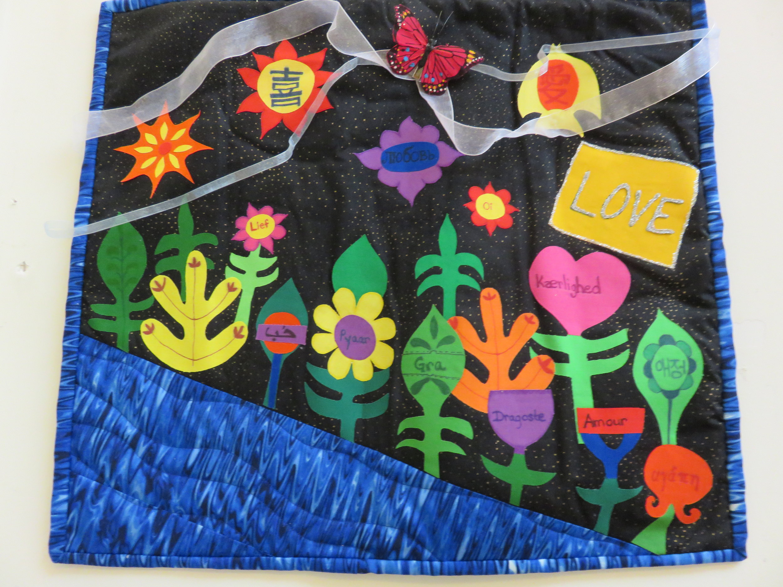 First time entry by Laurie Winburn, titled “It’s a World of Love.”