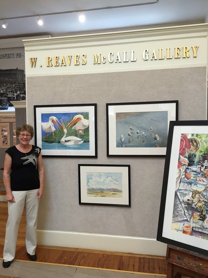 Artist Barbara Rohde of Durham, NC stopped by the Hartsville Museum to observe her painting “Gossip”. This work is transparent watercolor on paper and received the Supporters of Artists (SOA) Award.