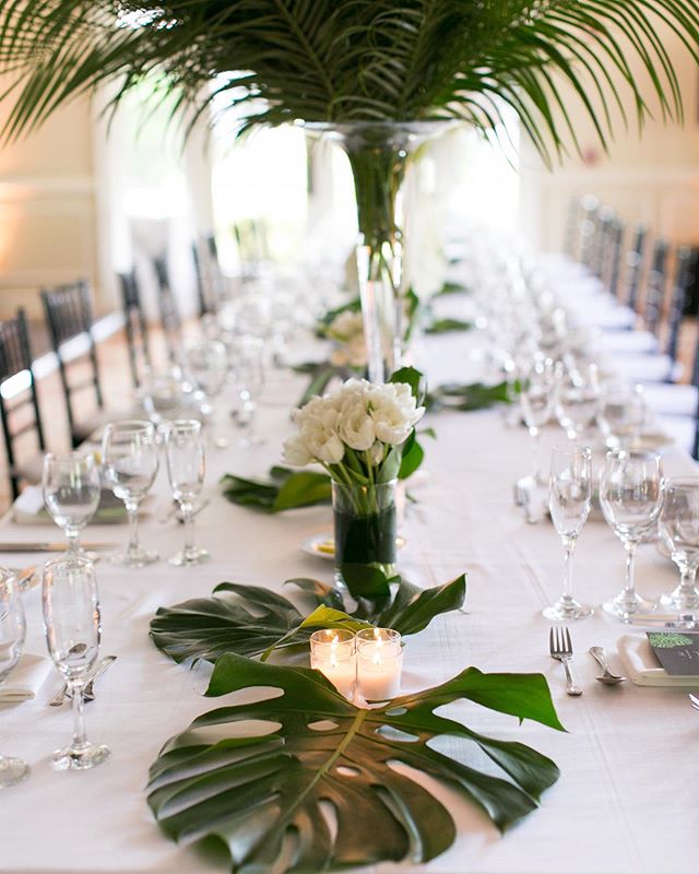 Tables dressed in tropical foliage and single element arrangements #weddingflowers #floraldesign .
.
.
#monstera #palm #tulips #flowers #flower #flowerstagram #flowersofinstagram #charlestonstreet #floral