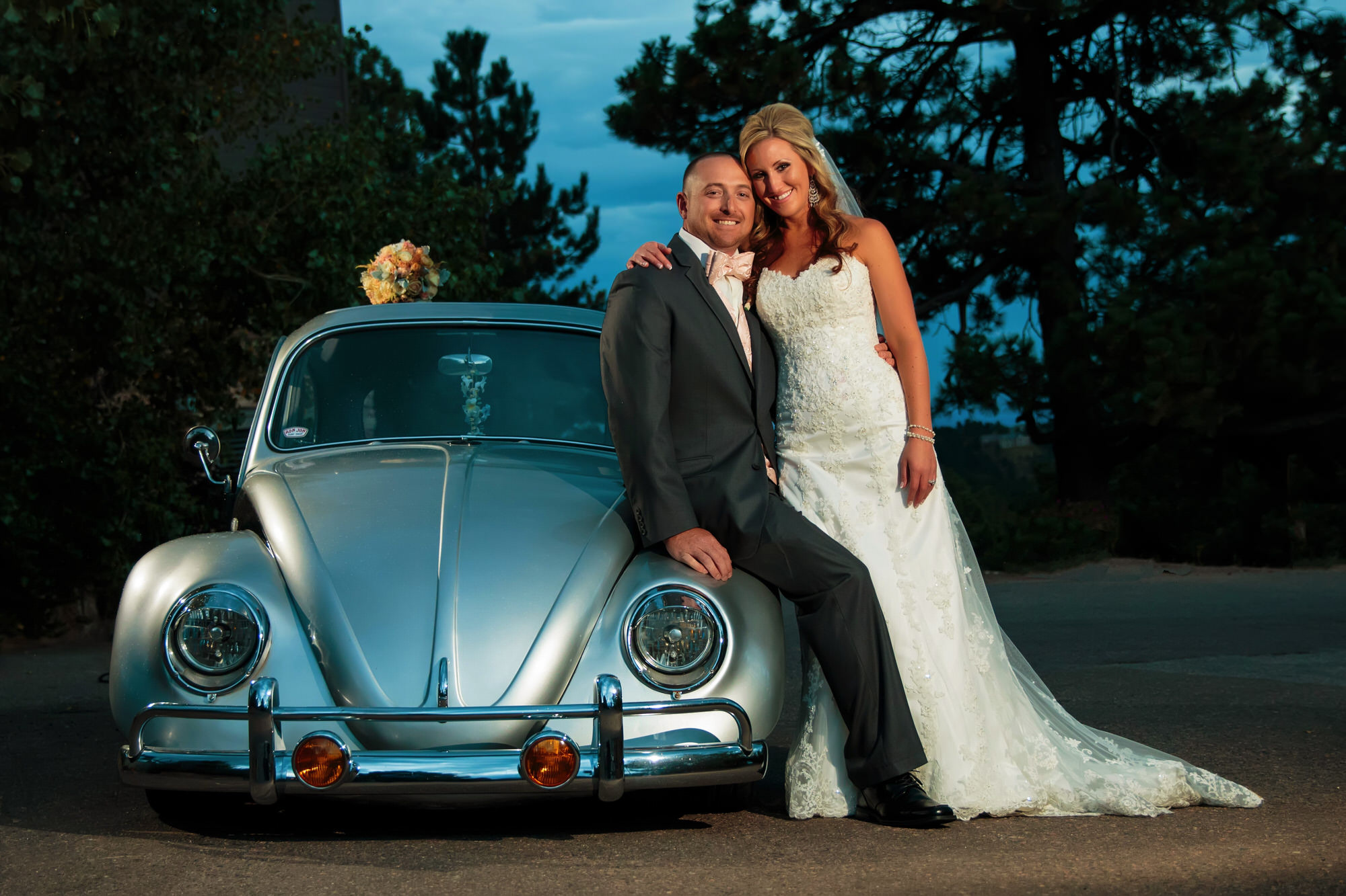 Bride and groom lounge next to a classic Volkwagen beetle during a mount vernon canyon club wedding (Copy)