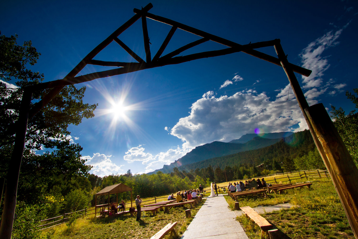 a bright summer day ceremony as captured by tomKphoto, wild basin wedding photographer