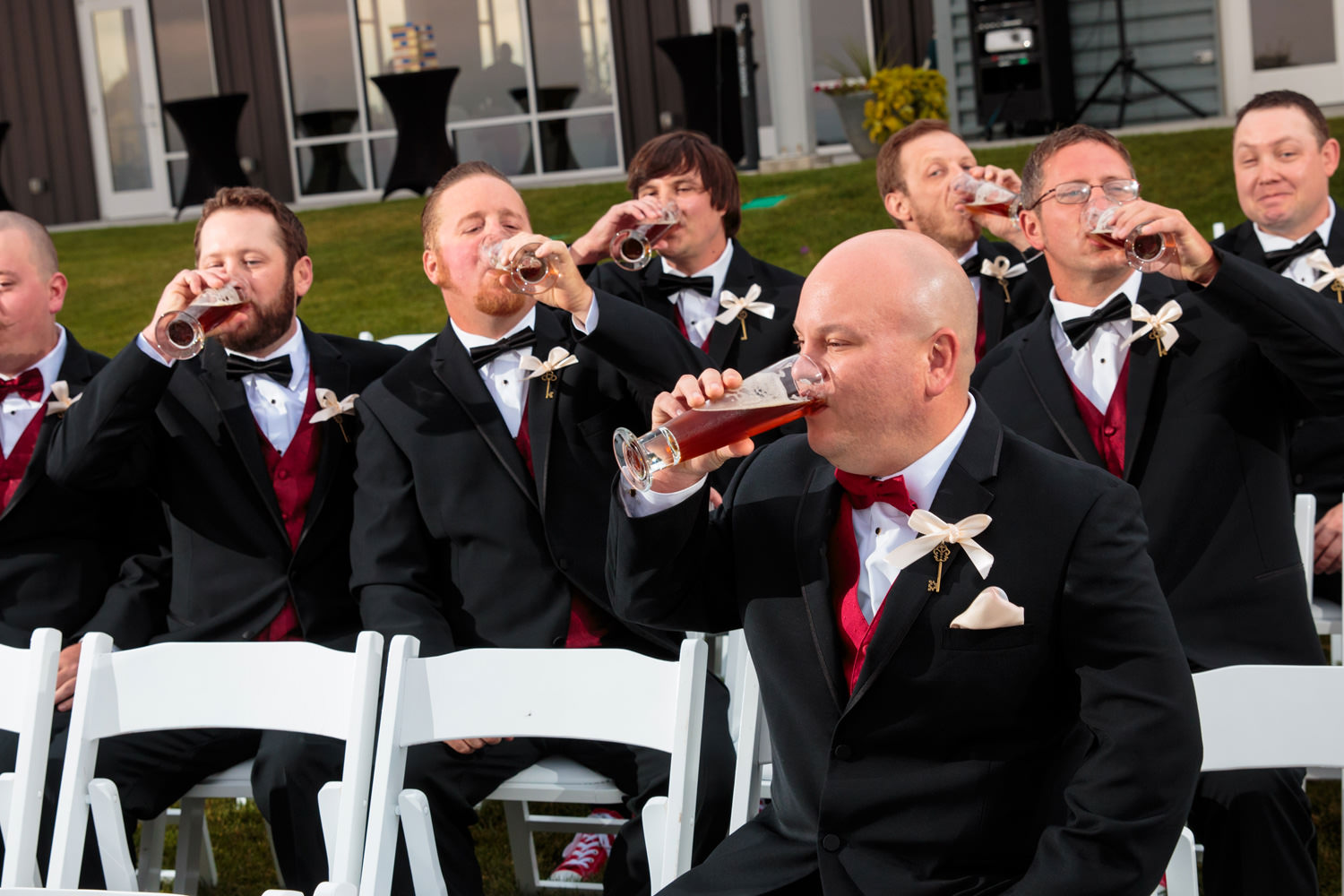 groomsmen drinking beer as captured by tomkphoto windsong estate wedding photographer