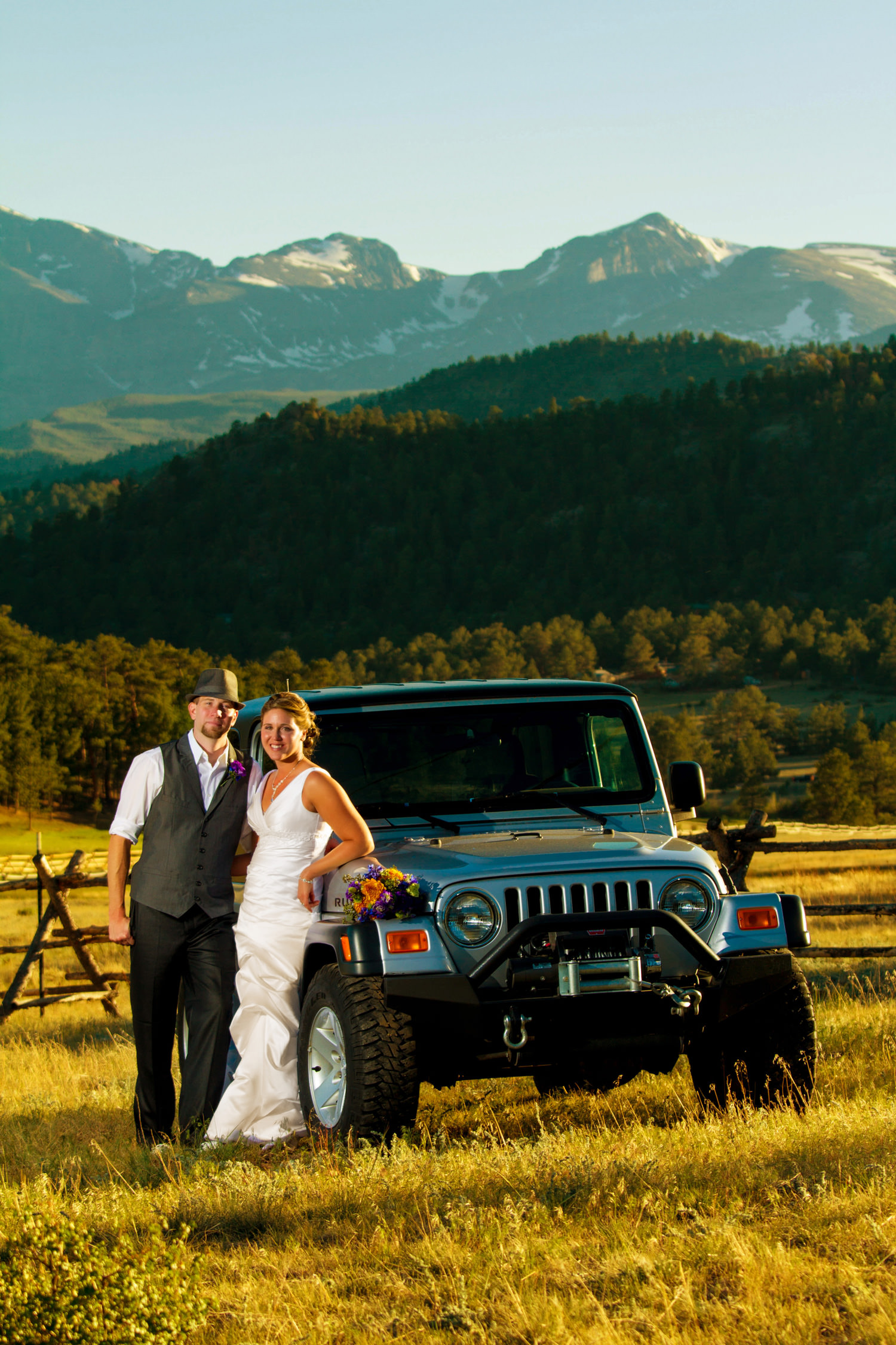 bride and groom with a off road jeep during a black canyon inn wedding in estes park, colorado