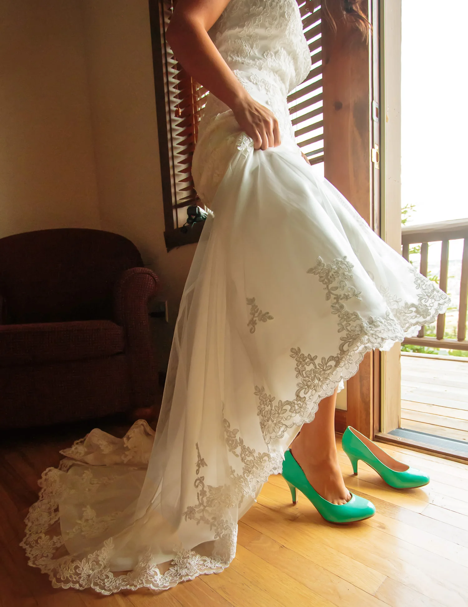 Bride slips into shoes during a Taharaa Mountain Lodge wedding in Estes Park, Colorado
