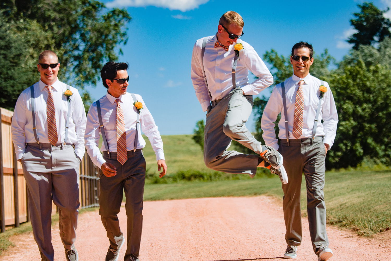 Groom jumps for joy with groomsmen during a preserve and bingham hill wedding near fort Collins, Colorado