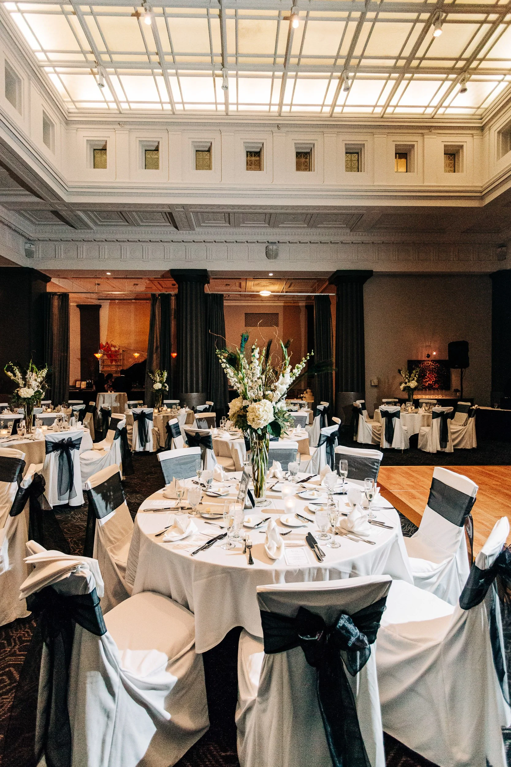Reception tables are set for guests during a Magnolia Hotel wedding in Denver, Colorado