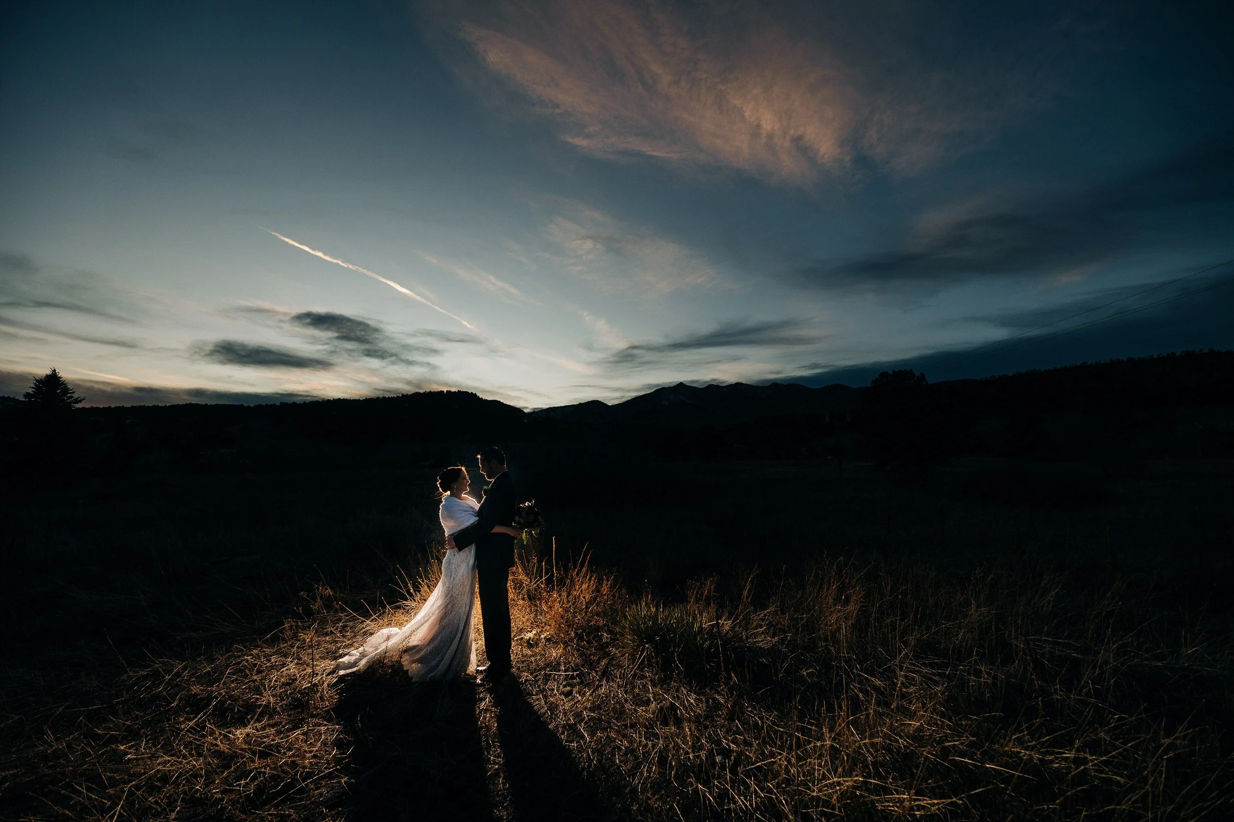Bride and groom exchange private vows in soft Summer alpine glow during a Greenbriar Inn wedding reception in Boulder, Colorado