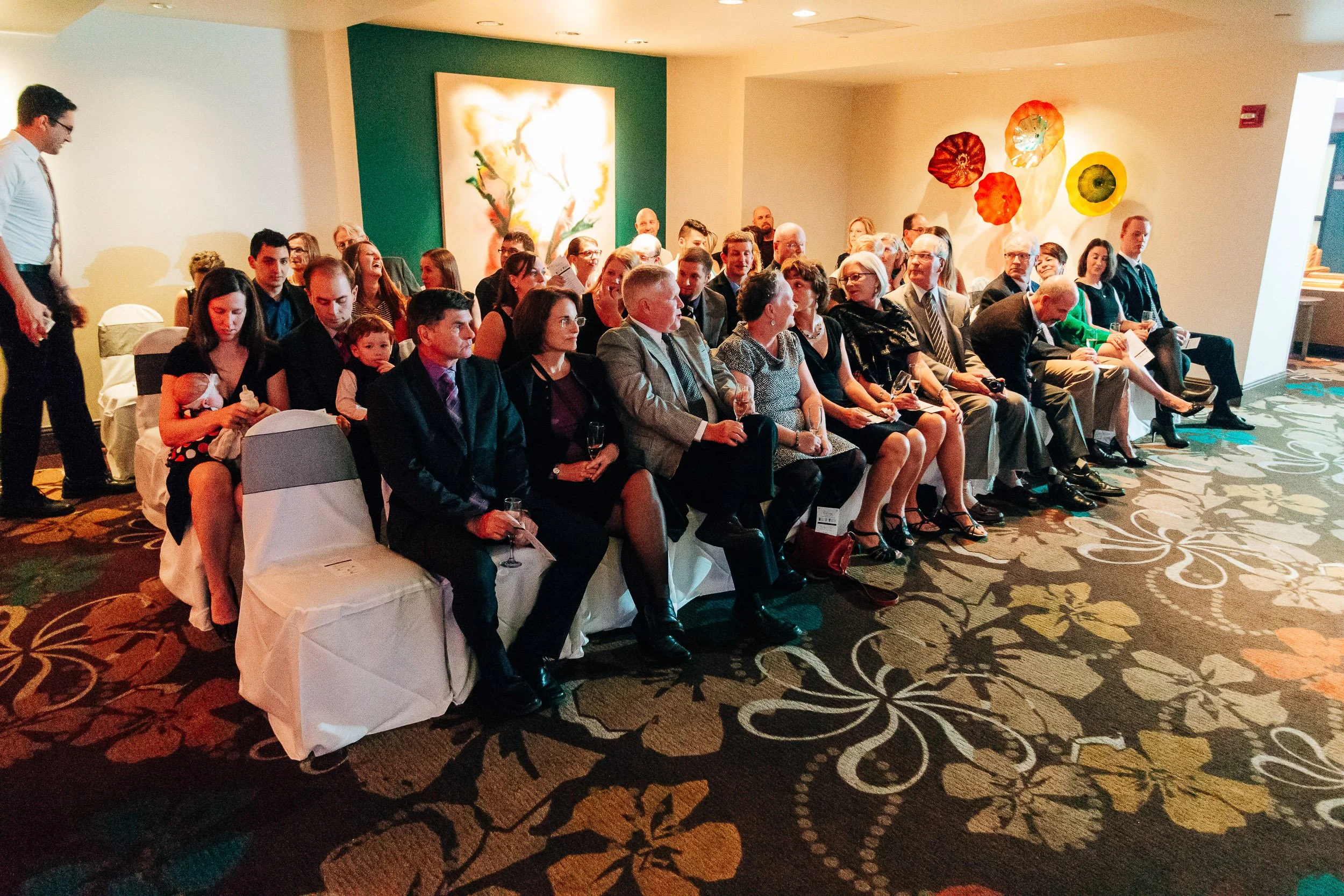 Guests are seated awaiting the processional during a Magnolia Hotel wedding in Denver, Colorado