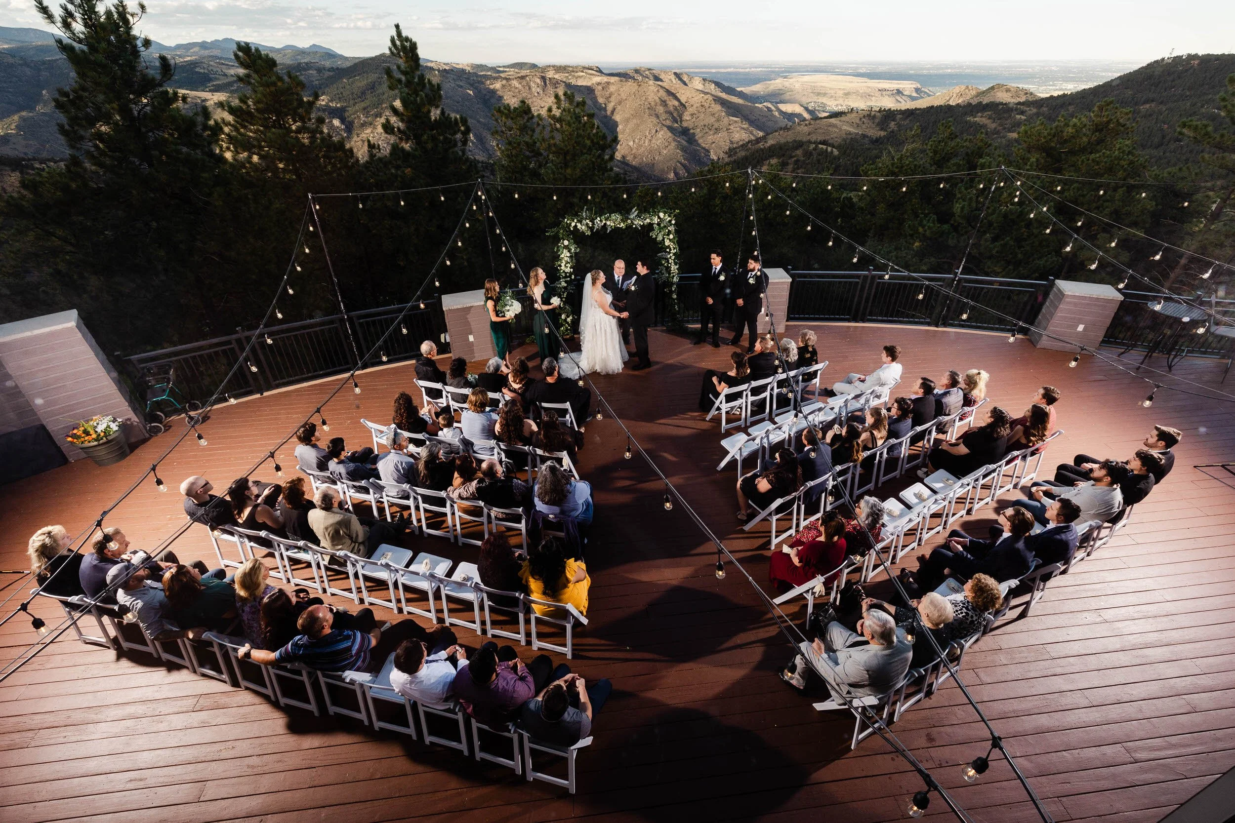 Marriage ceremony in front of 65 guests on a deck overlooking a canyon during a Mount Vernon Canyon Club wedding in Golden, Colorado