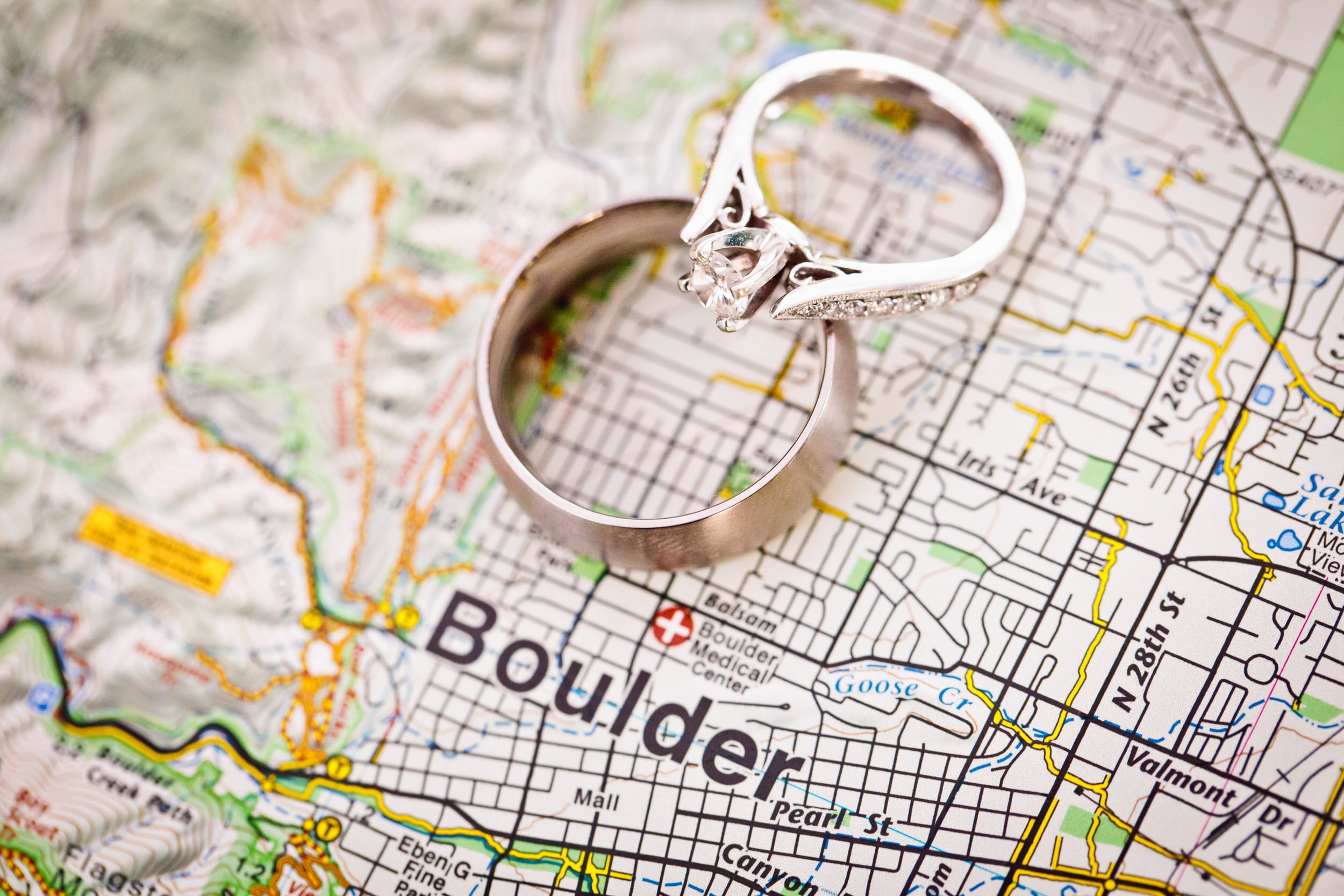 Wedding rings on a paper map of Boulder, Colorado during a wedding at Greenbriar Inn