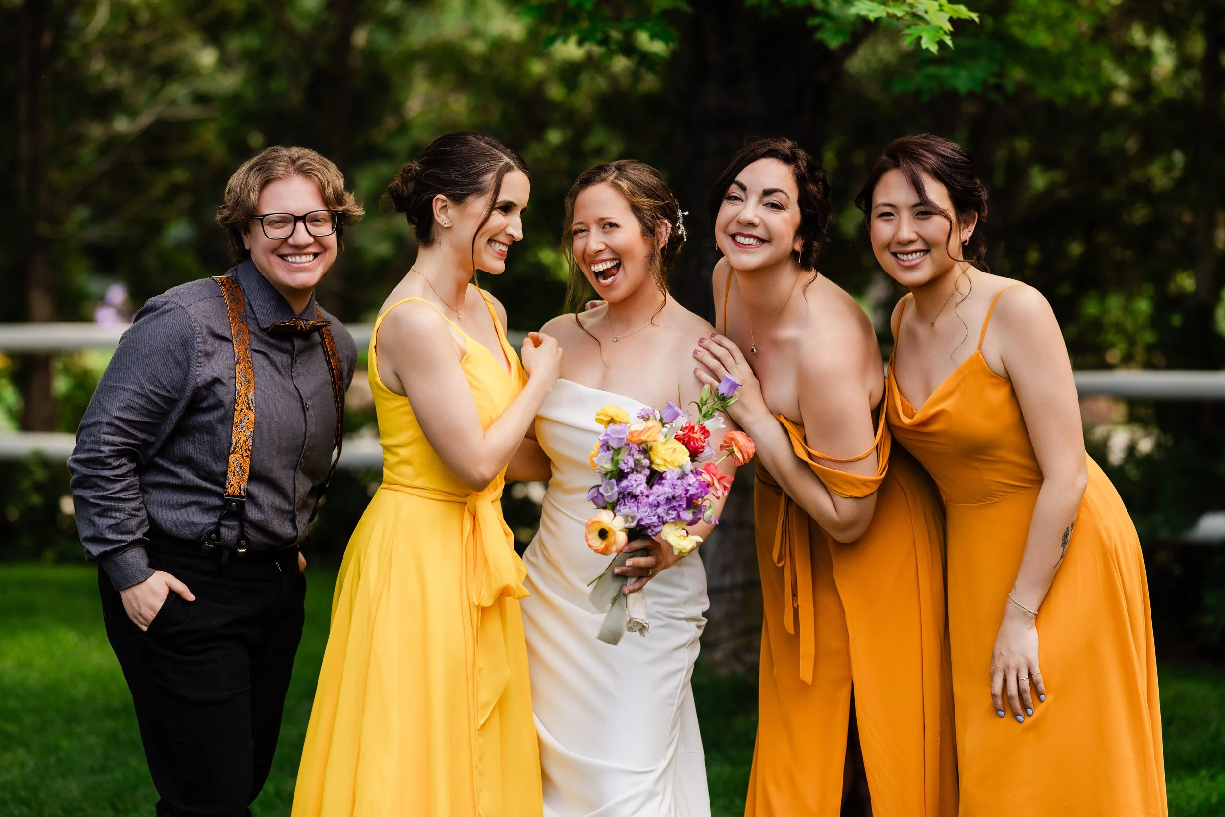 A bride and her bride's people laugh during formal portraits before a Greenbriar Inn wedding in Boulder, Colorado