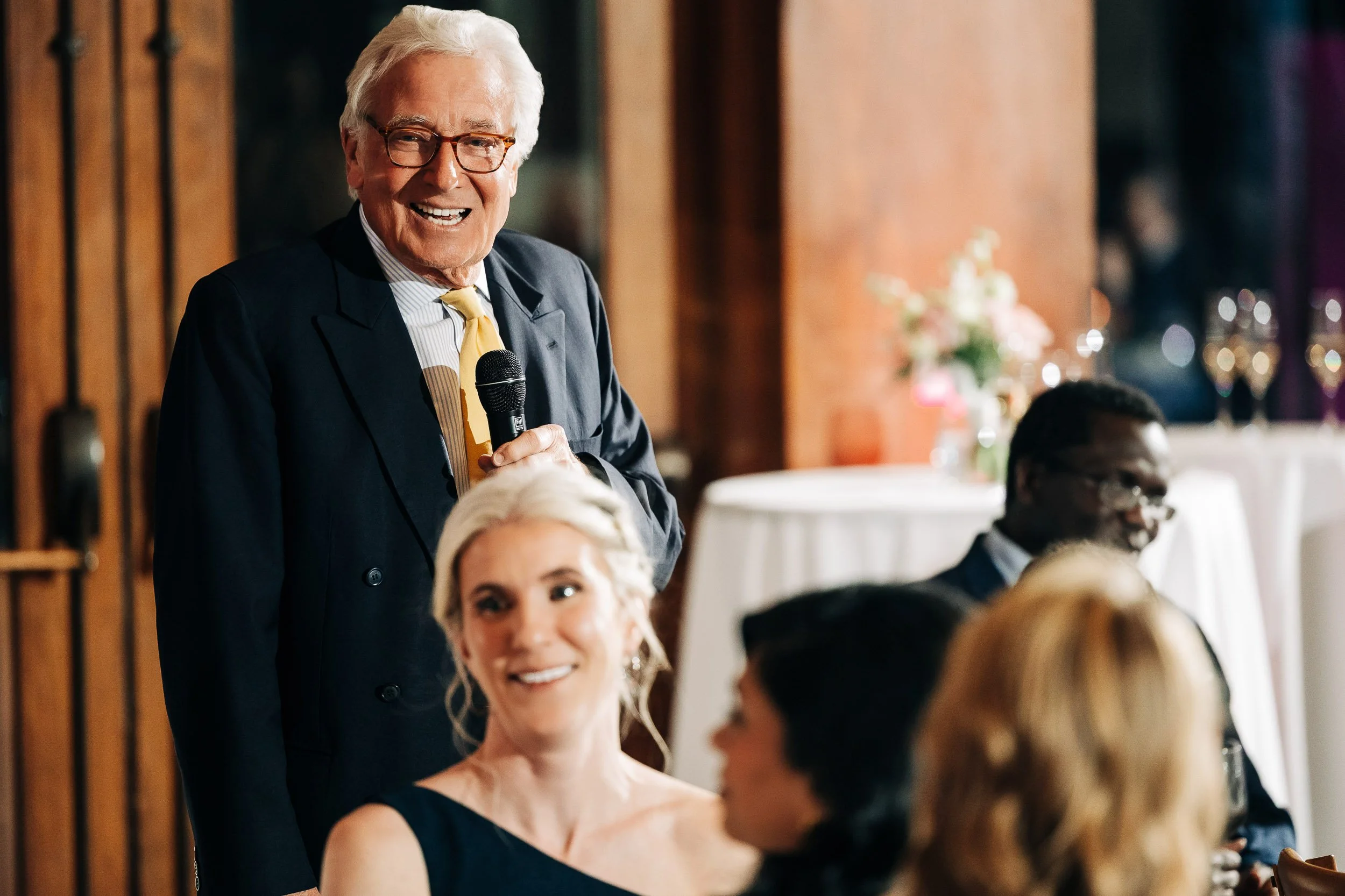 Father of the Bride completes a funny story and offers a toast during a Donovan Pavilion wedding reception in Vail, Colorado