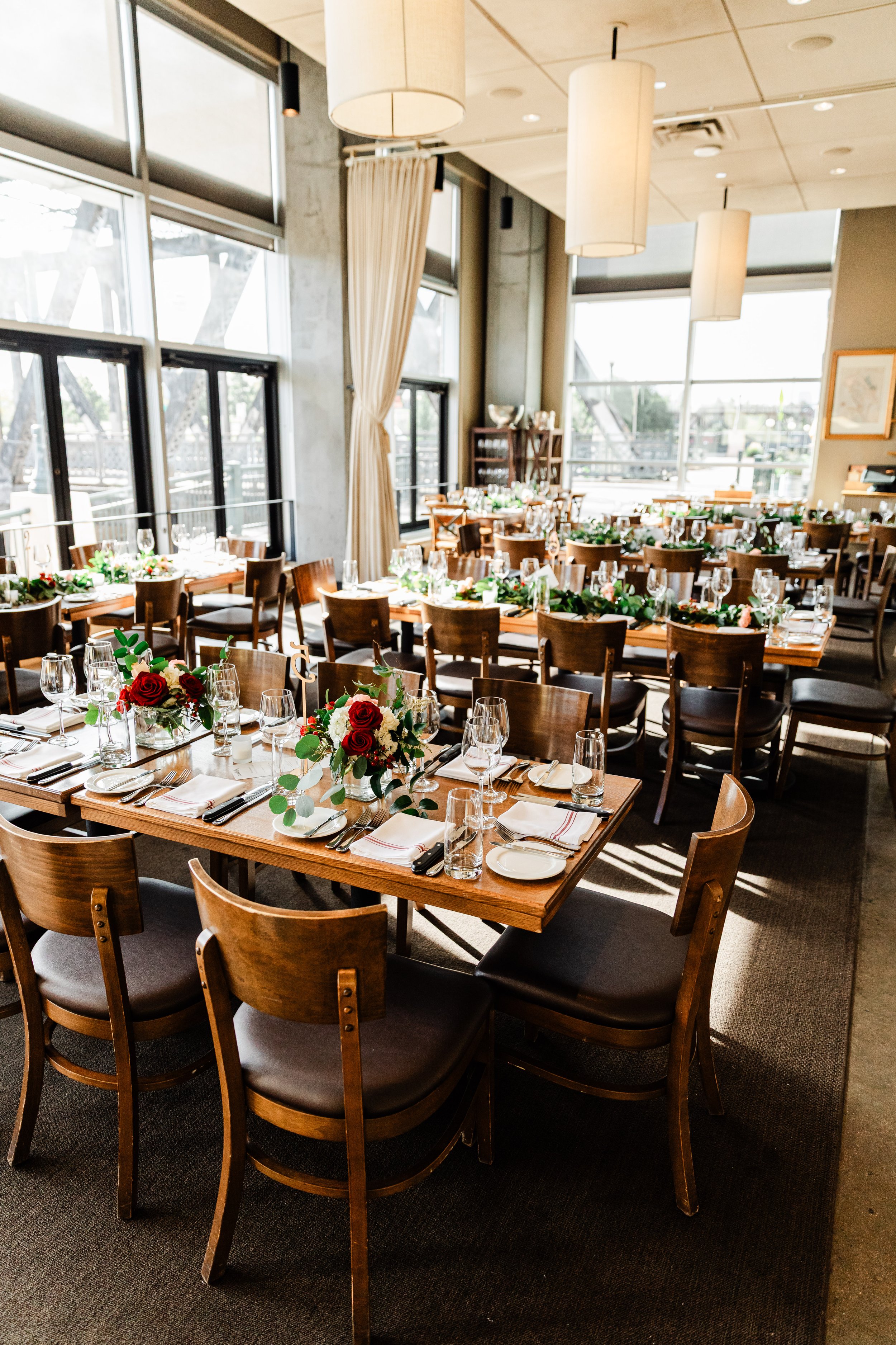Long dinner tables decorated and ready for guests durinag a Coohills Restaurant wedding reception in Denver, Colorado