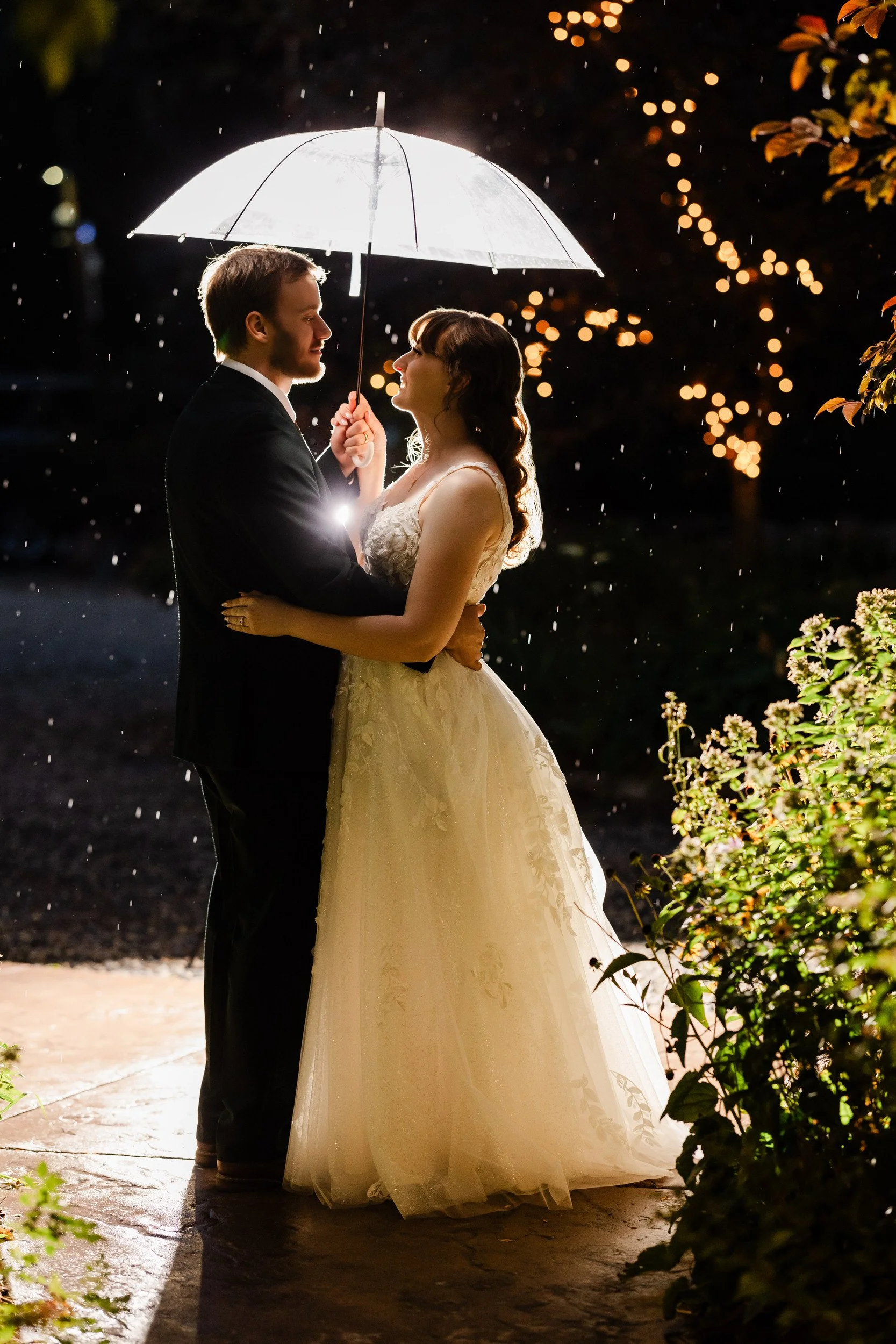 A couple takes in the last moments of a rainy day under an umbrella during a Greenbriar Inn wedding in Boulder, Colorado