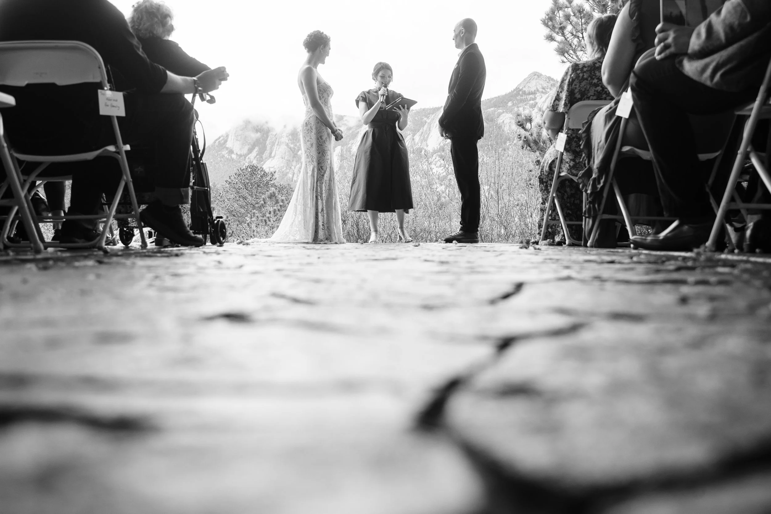 A bride and groom exchange vows as photographed from the ground during a Black Canyon Inn wedding in Estes Park, Colorado.