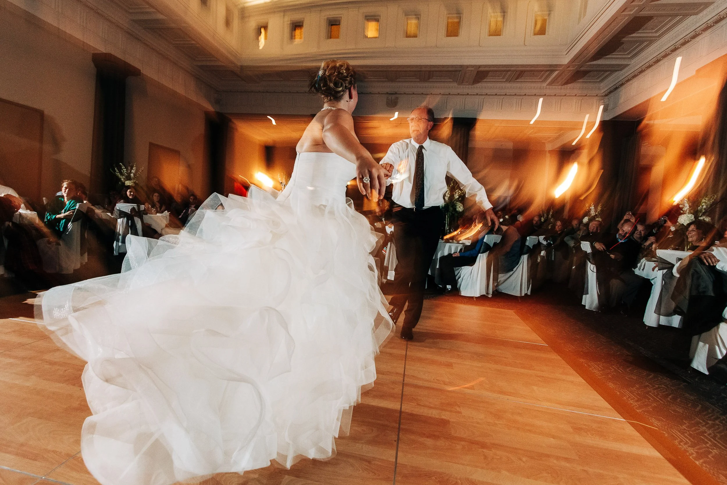Bride and groom spin during their first dance during a Magnolia Hotel wedding in Denver, Colorado