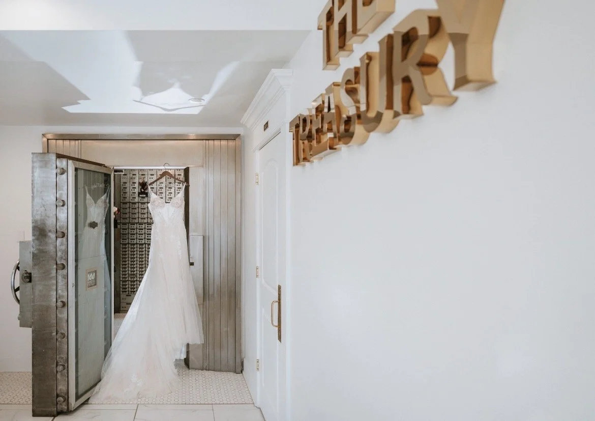 Wedding dress hanging in the historic bank vault at The Treasury wedding venue in Delavan Wisconsin.