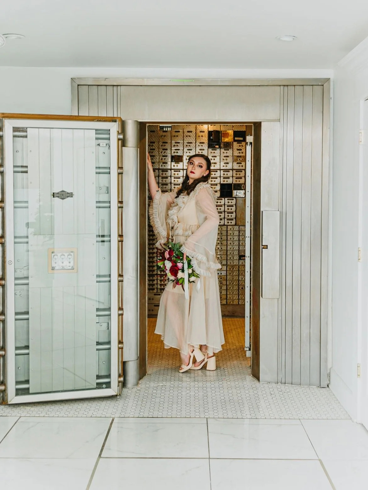 Bride standing inside the historic bank vault at The Treasury wedding venue in Delavan Wisconsin.