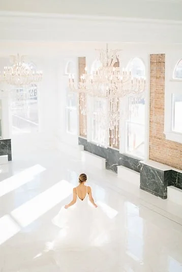 Bride walking through the chandelier-lit reception space at The Treasury wedding venue in Delavan Wisconsin.