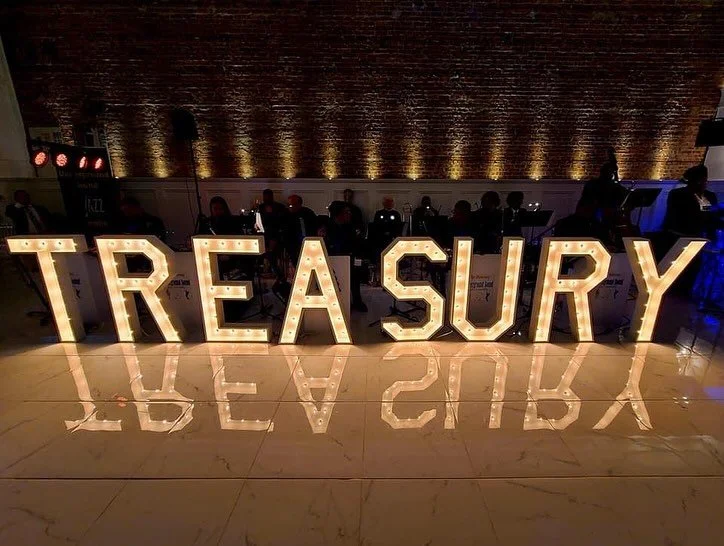 Illuminated Treasury sign at a wedding reception inside The Treasury venue in Delavan Wisconsin.