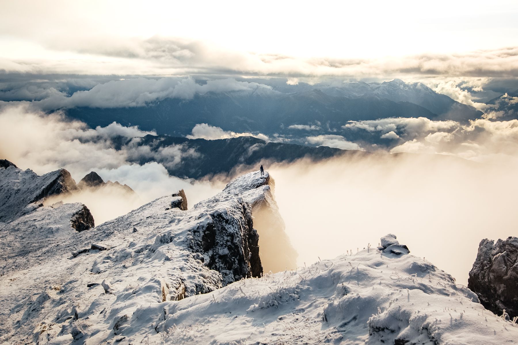 Fabio overlooking the valley filled with clouds and fog.