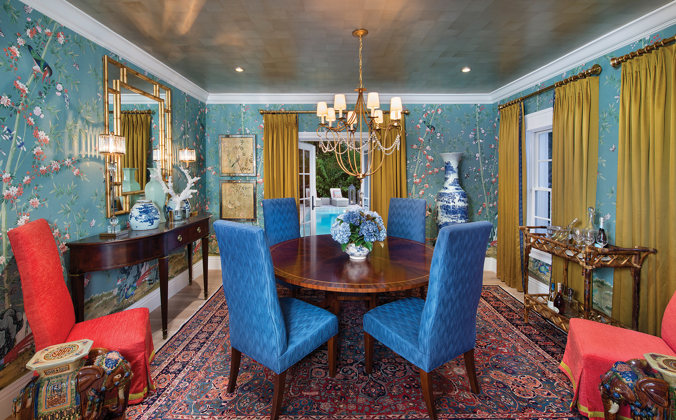  Filled with saturated color and textural layers, the dining room is a space that gives the homeowners a truly formal entertaining area. American made chinoiserie wallpaper represents a new opportunity for designers as it replaces the more expensive 
