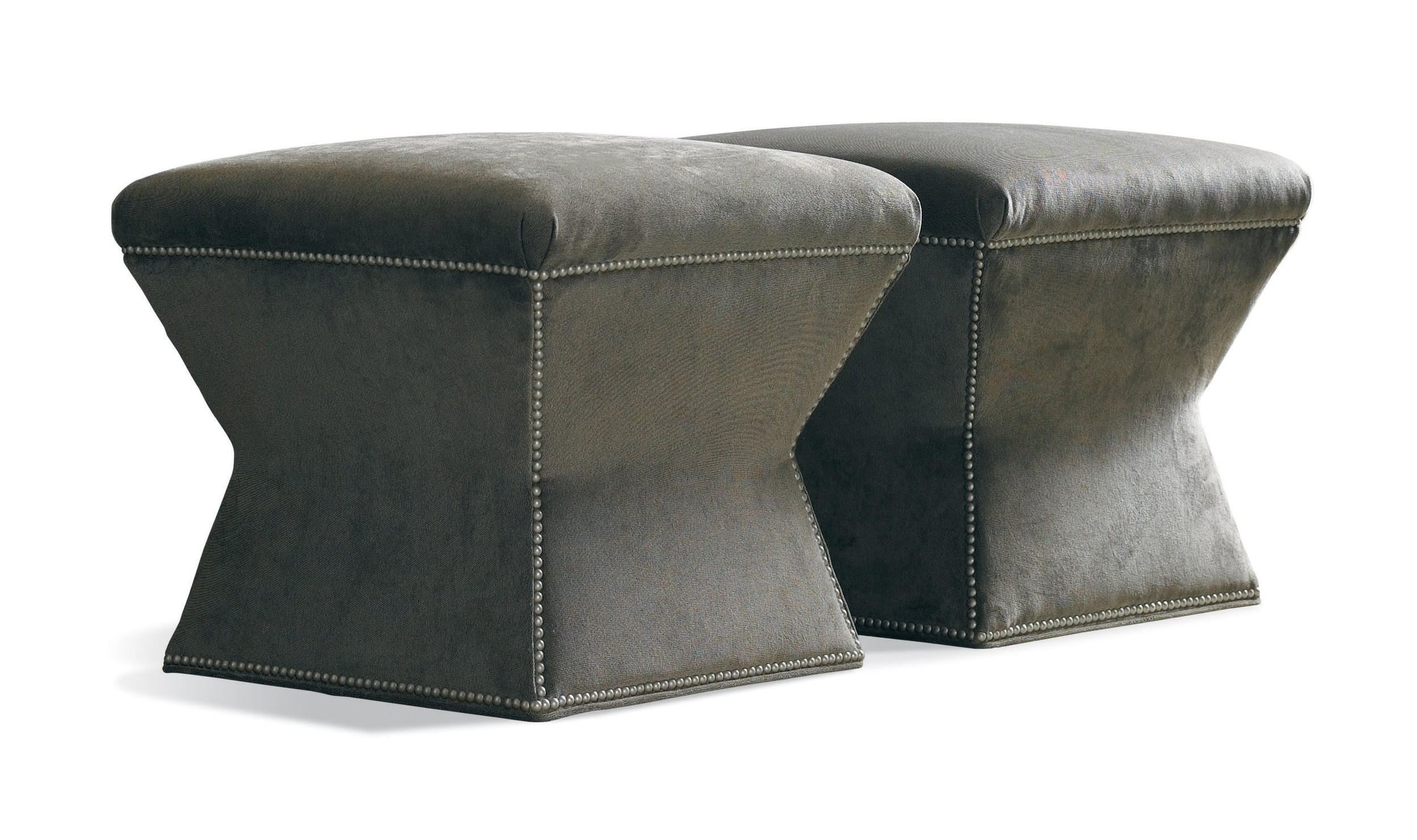 These ottomans bring in warmth and add to the mixed metals in the home through their metallic copper and silver print with nailheads.