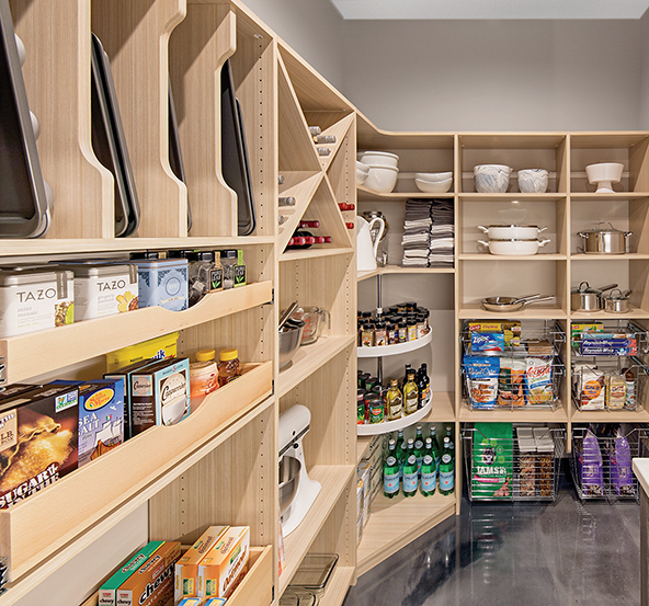  This pantry combines two popular features—the “wine x” storage cubbies and vertical shelf dividers. Pull-out drawers, baskets and Lazy Susans add valuable storage options. 