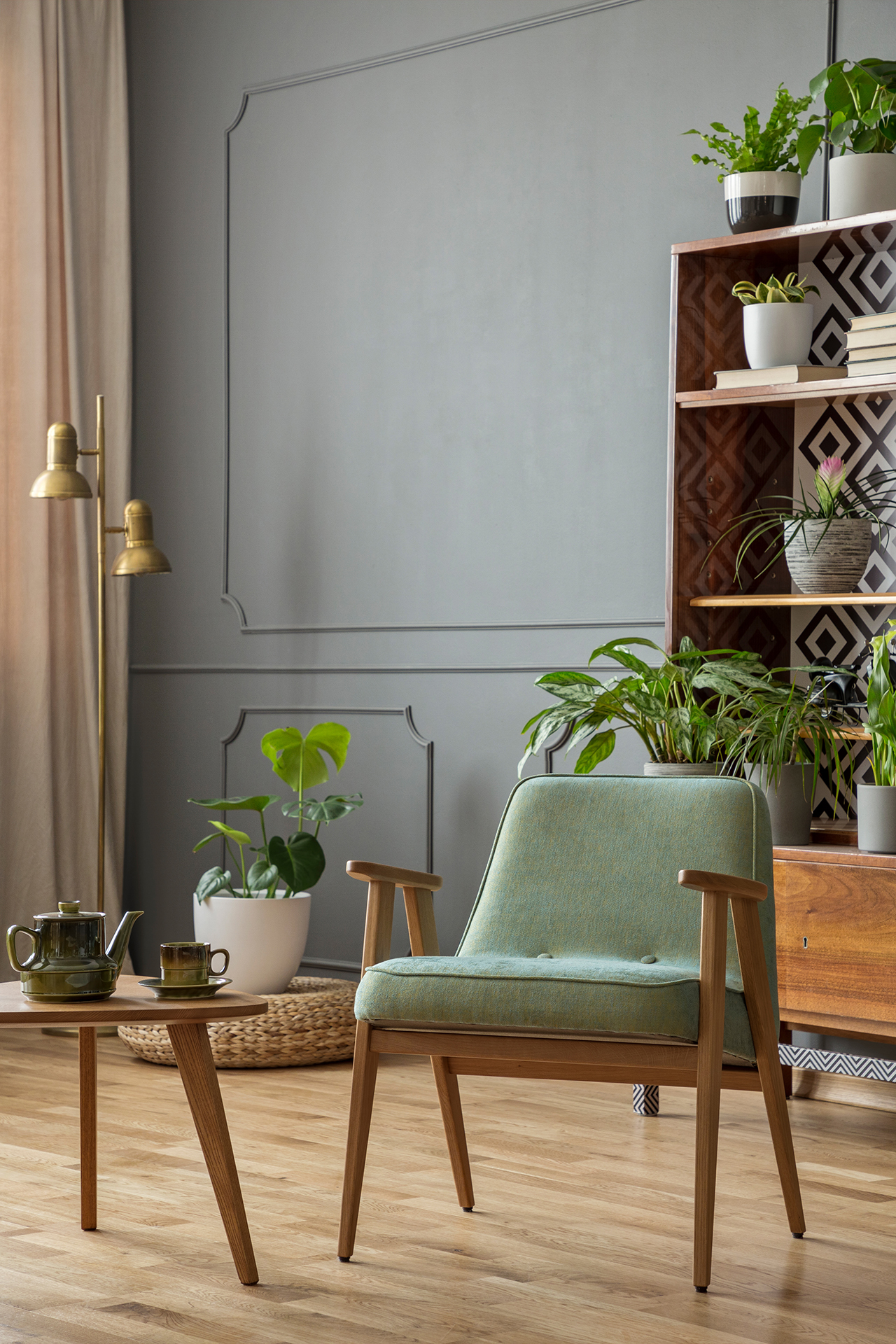 green-armchair-next-to-wooden-table-in-grey-JX2UV8S.jpg