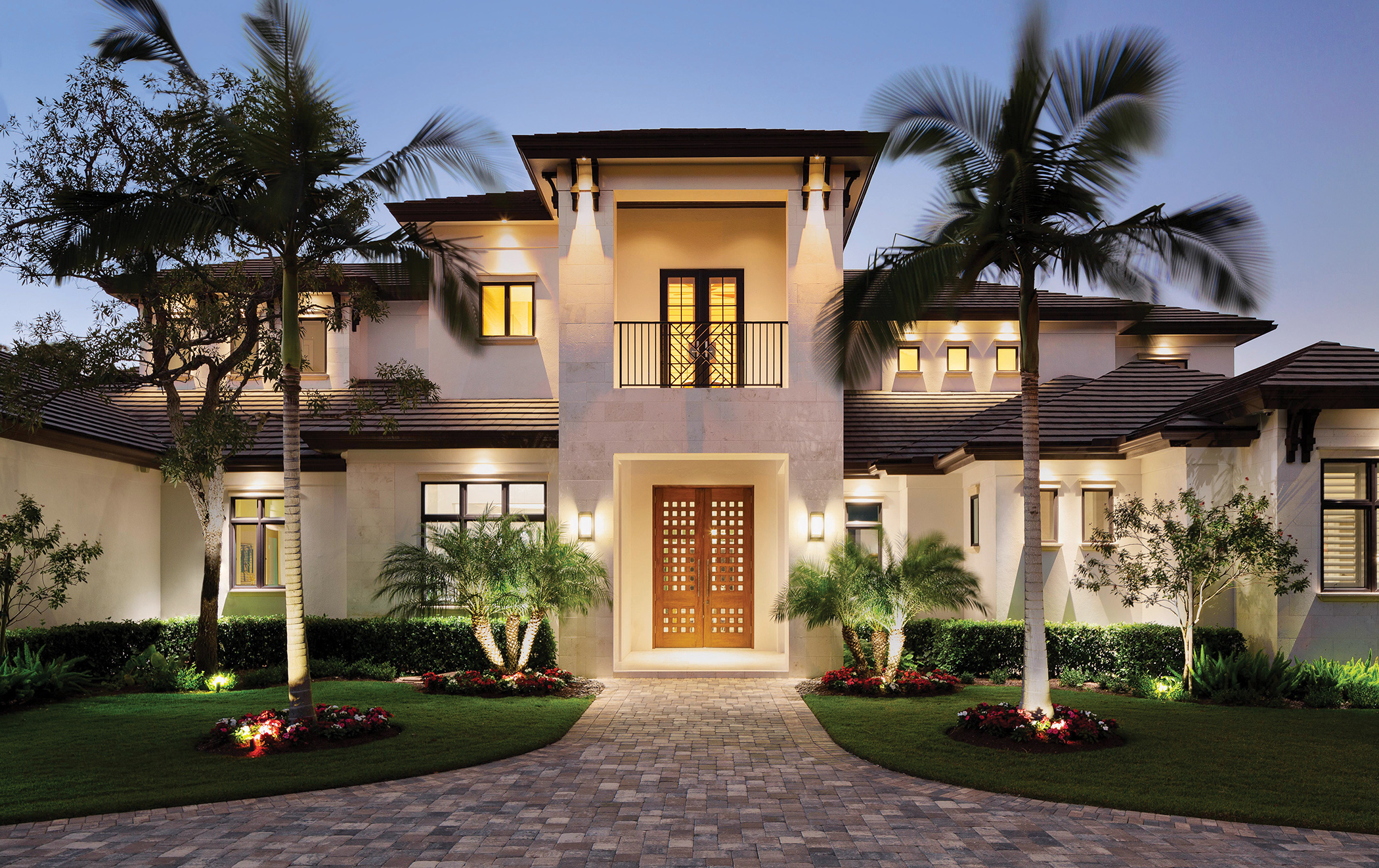  The home’s sand finish stucco exterior with shell stone and cypress accents complements a large, circular paver driveway with side entry garage. The landscaping features privacy hedges and numerous coconut trees. As a special treat, fruit-bearing or