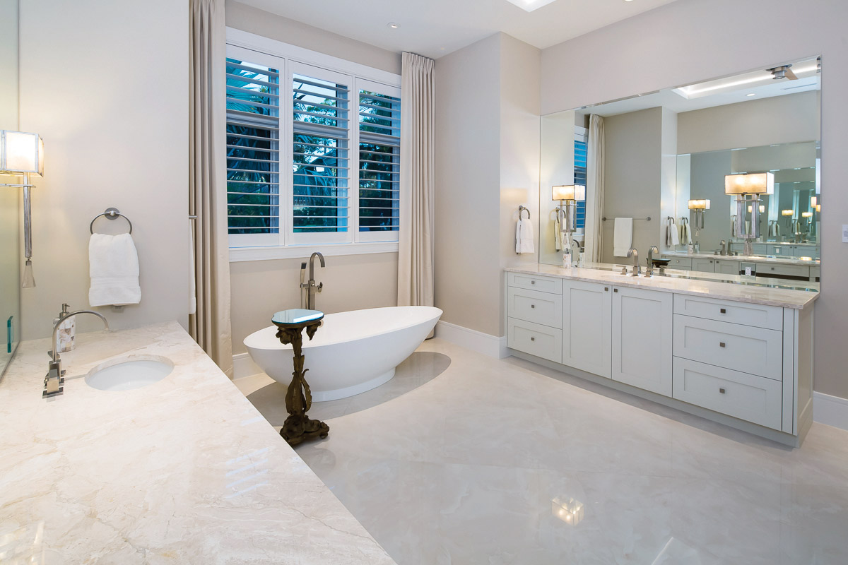  In the master bath, separate vanities with Rutt cabinets enhance the striking marble counters and brushed chrome faucets. The bathroom also has separate his and hers dual flush water closets. The bath features a Napoli freestanding tub with floor mo