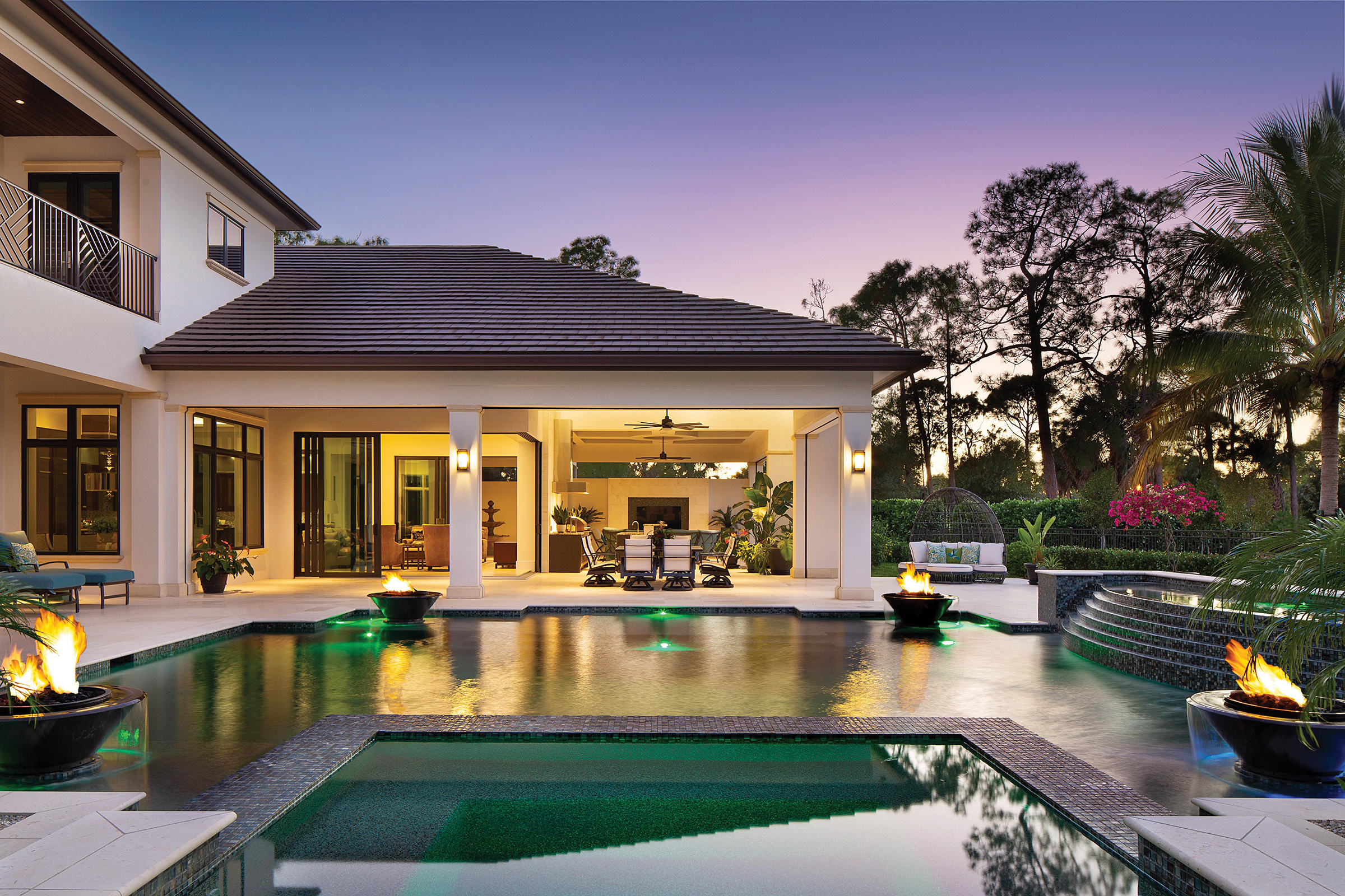  The focal point of the award-winning outdoor living space is the stunning pool with glass tile, four fire bowls, and spa with tiled stair details that features its own waterfall cascade. The pool is heated for year-round swimming and a saltwater sys