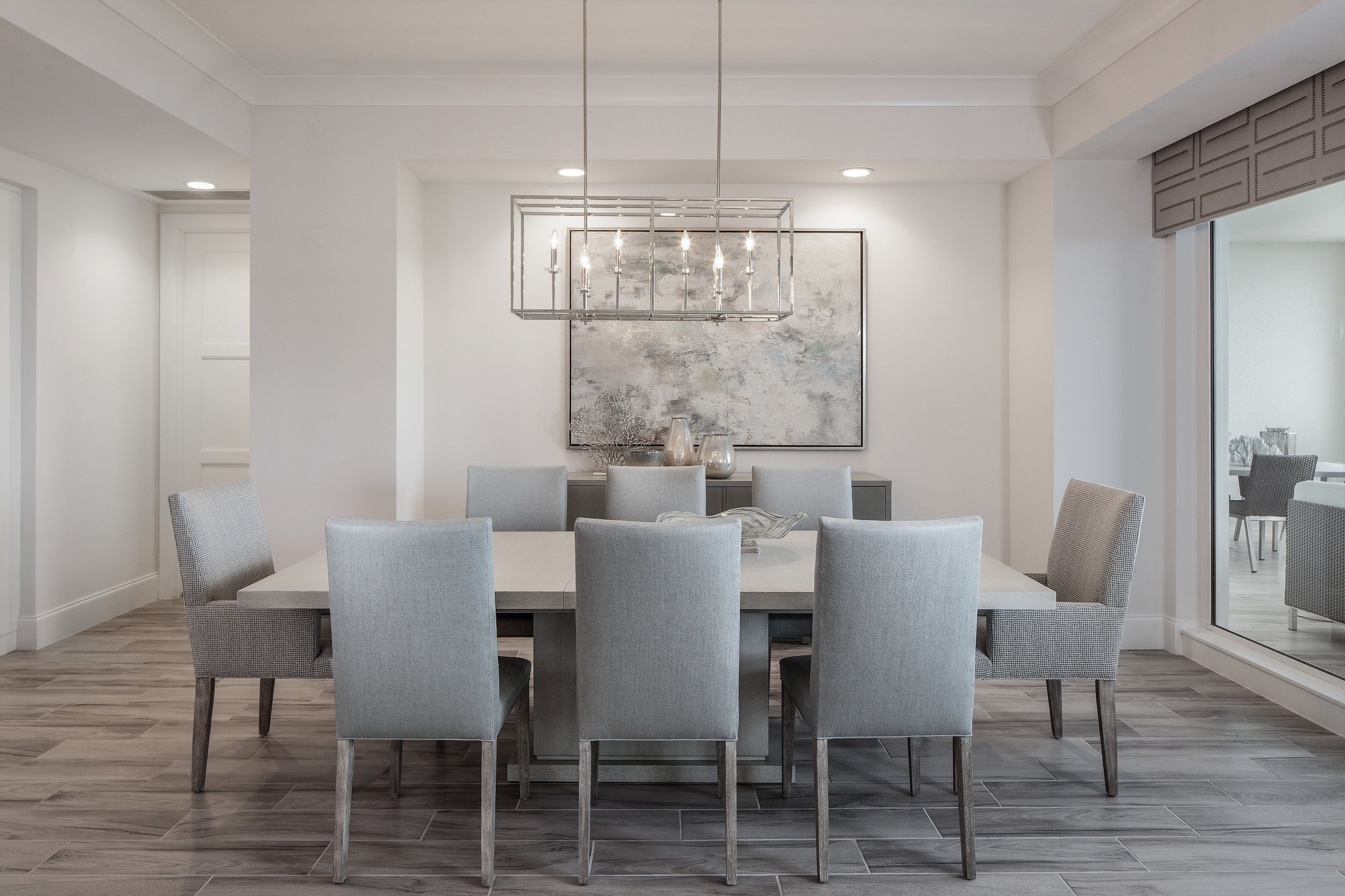  This dining room is a wonderful venue for dinner parties both formal and casual. The space easily accommodates the large Vanguard table with driftwood finish. The painting beautifully matches the pale hues of the walls while the cornice, with custom