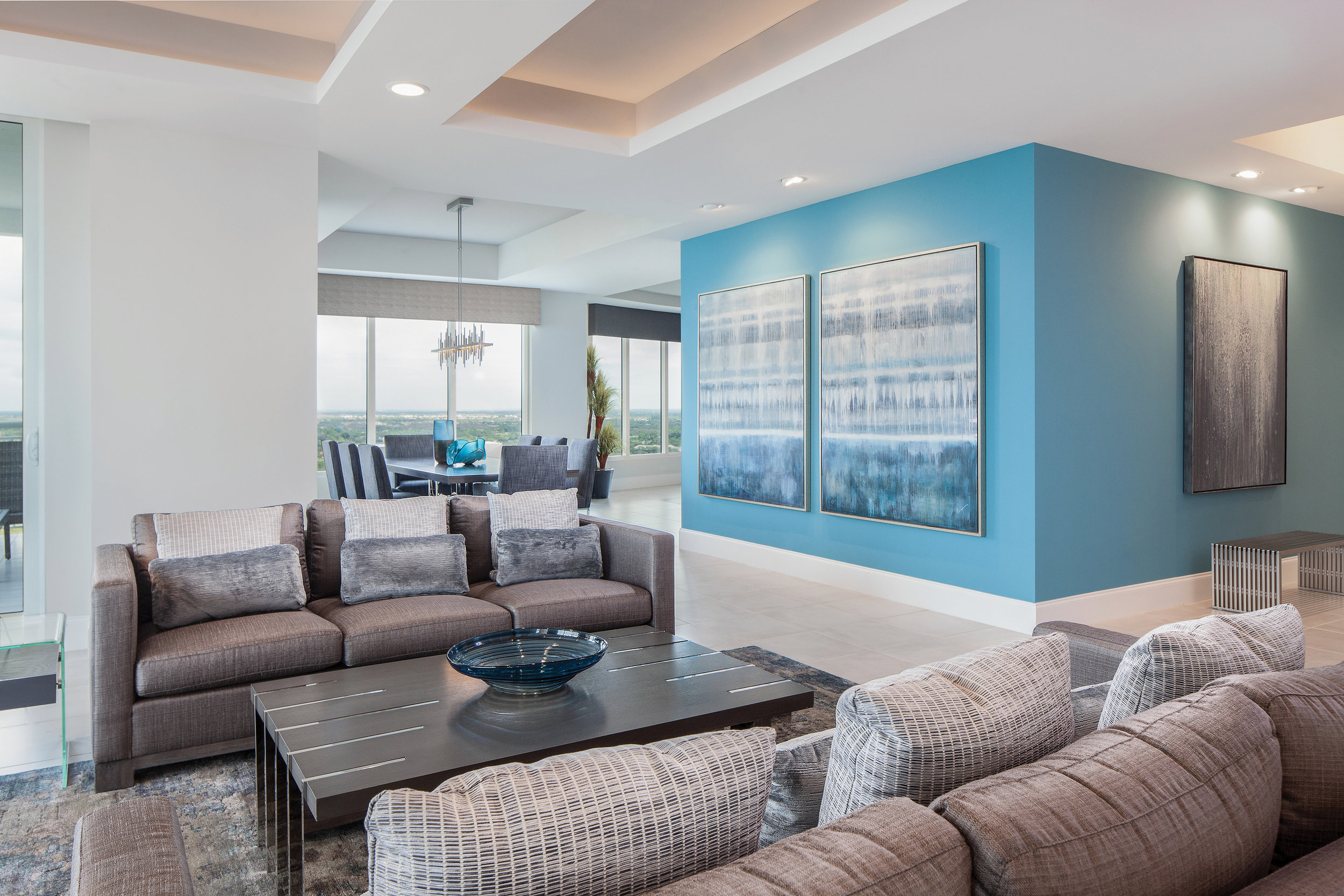  This penthouse condo features 4300 square feet of living space complete with expansive views and fantastic natural light. Combining the homeowners’ varied design aesthetics, natural tones are accented with pops of color. “The condo is owned by a won
