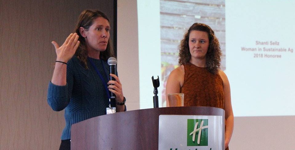 Board member Sophie Neems (right) presented Shanti Sellz with the 2018 Woman in Sustainable Agriculture Award.