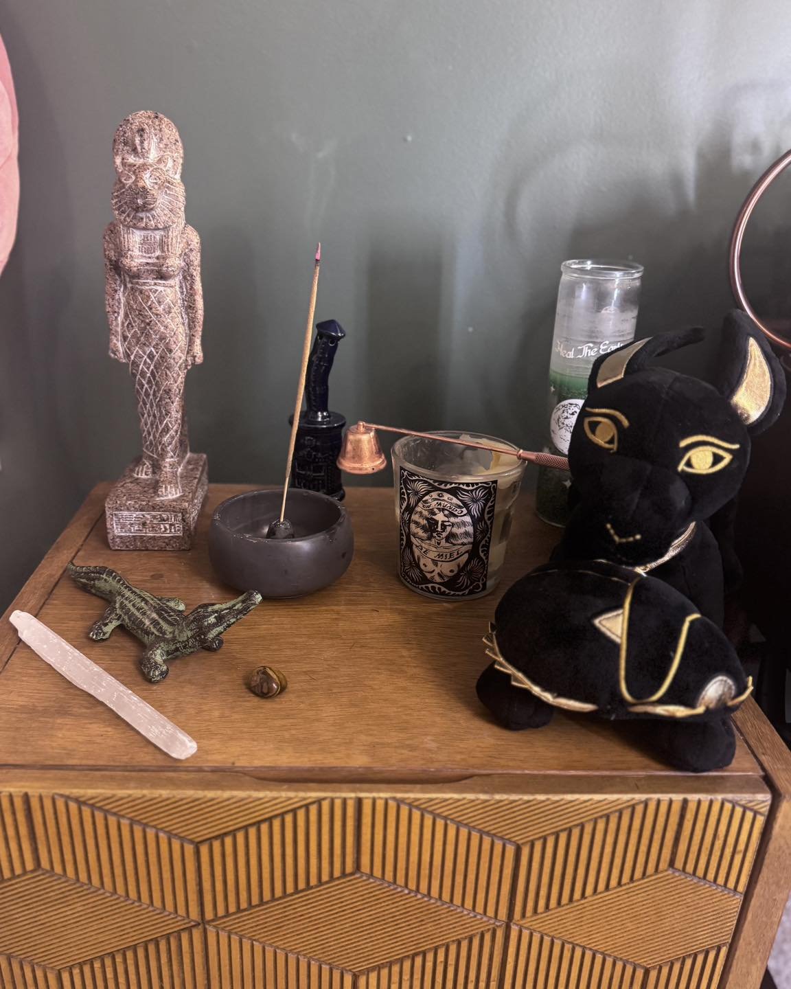 Christine&rsquo;s current altar setup complete with Sekhmet statue and Anubis plush! 

&bull;
&bull;
&bull;
Image description: A small altar setup with a statue of Sekhmet, a small alligator statue, some incense burning, a couple candles and an Anubi