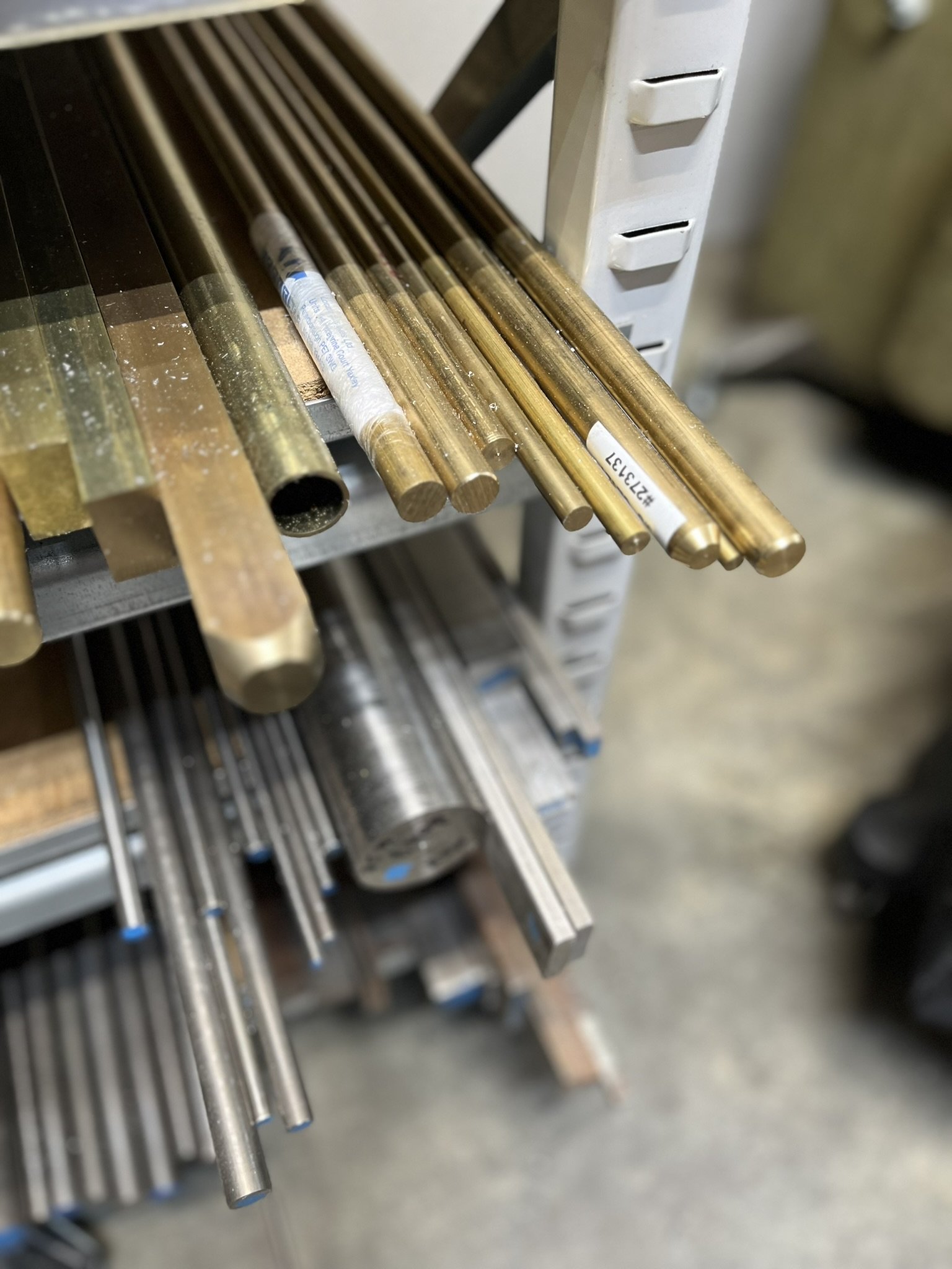 Shelf with aluminium, steel and plastic stock material for CNC machining.