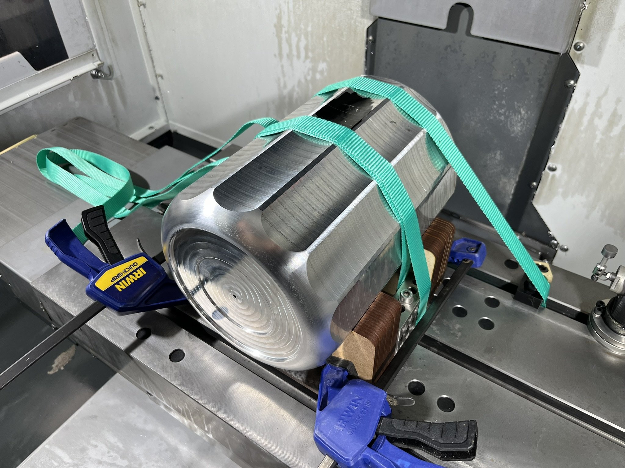 Large aluminium part strapped down and fixtured in a CNC mill to machine small features.