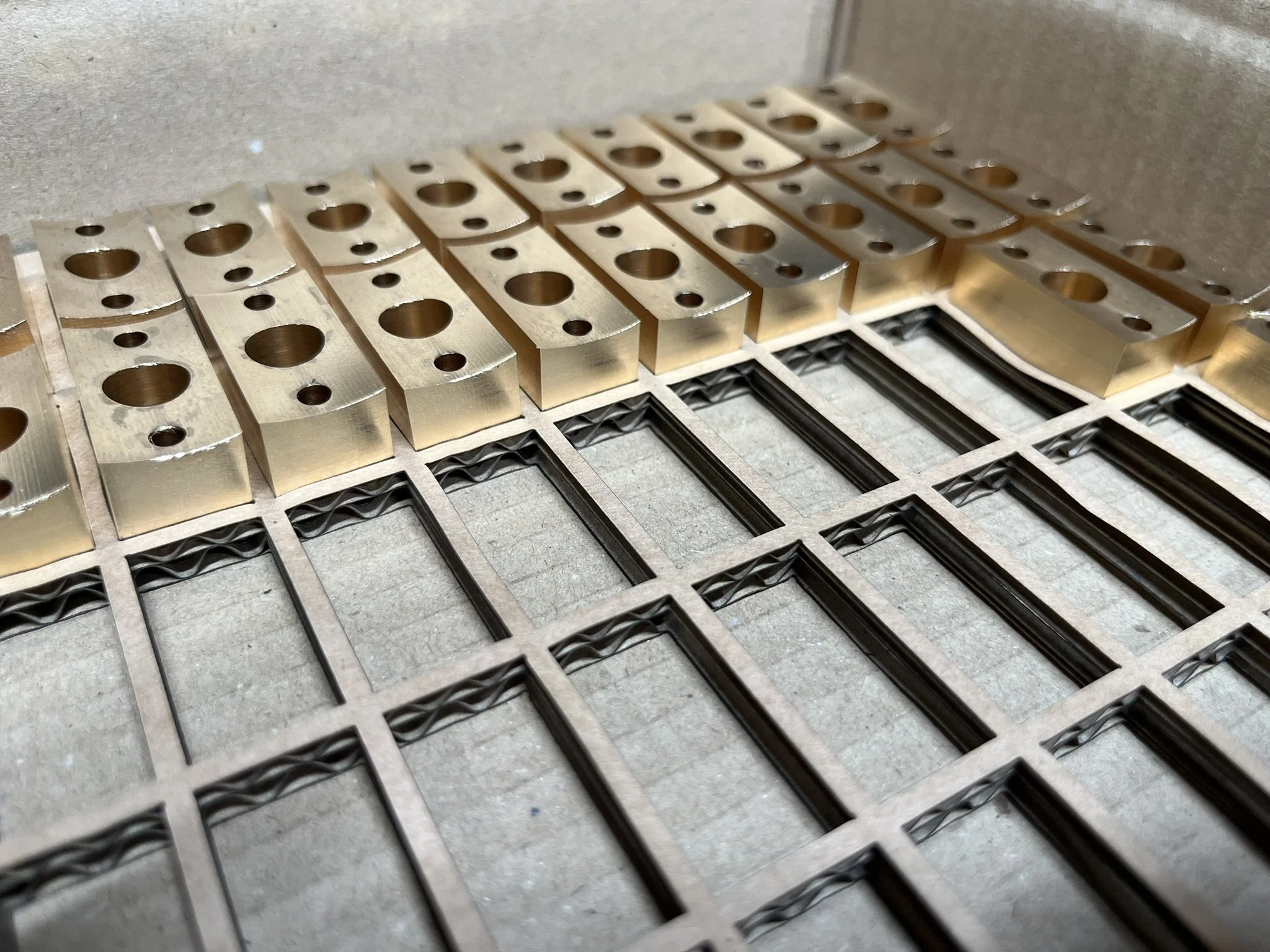 CNC milled parts in custom laser-cut packaging for batch supply