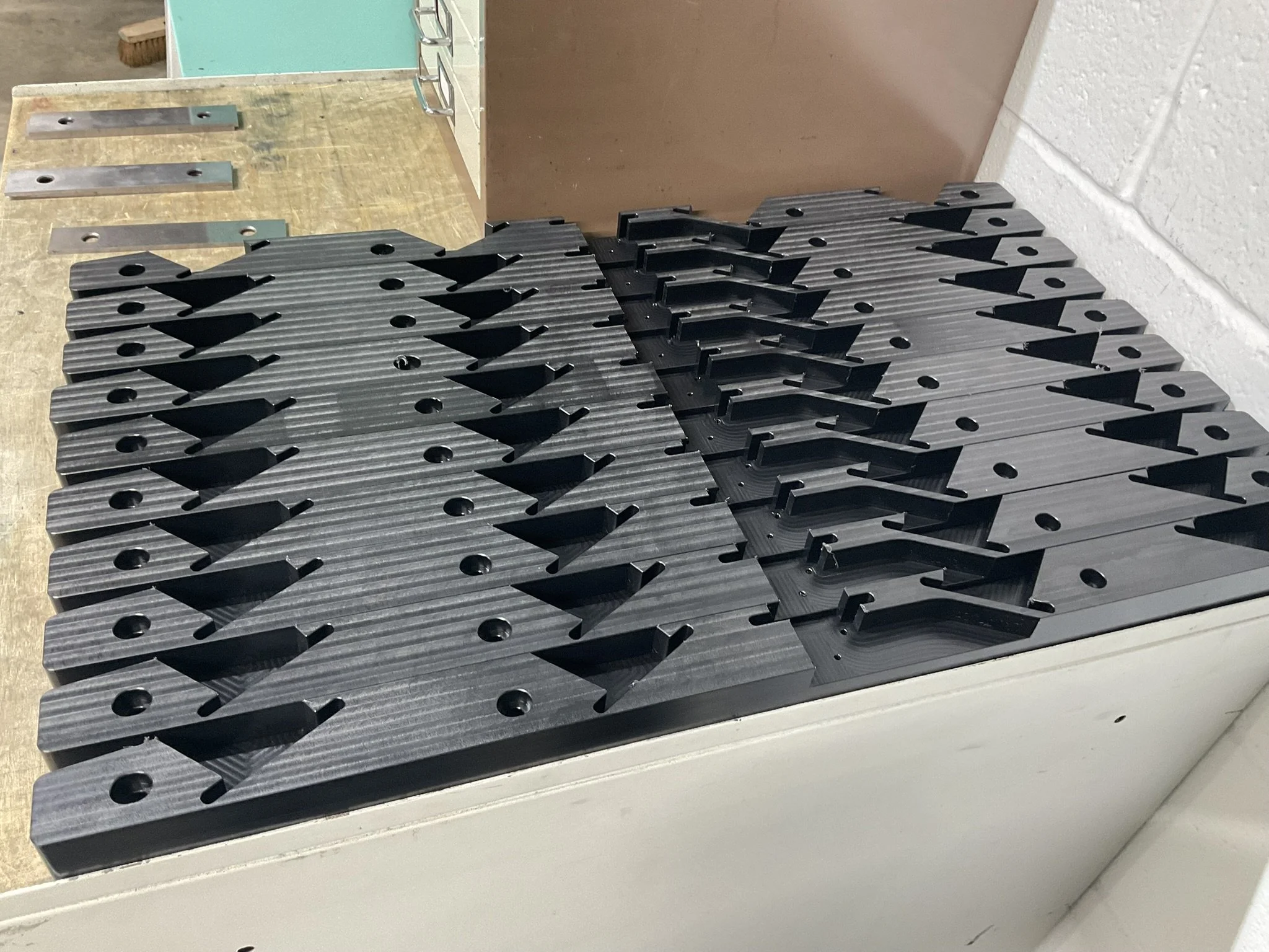 Batch of CNC-milled acetal parts stored on the shelf after machining.
