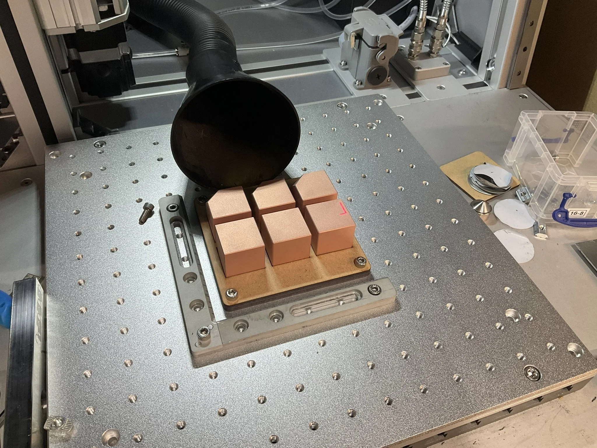 Copper components set in a jig ready for fibre laser marking.