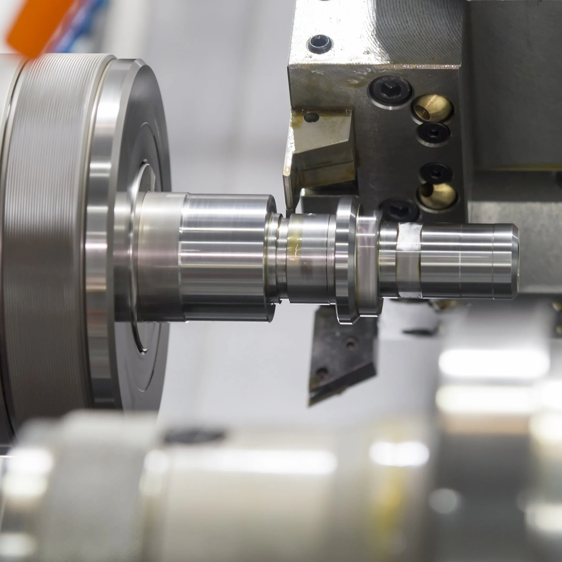 Turned metal shaft with tight tolerances, produced in-house at Karpas Engineering to integrate with laser-cut assemblies.