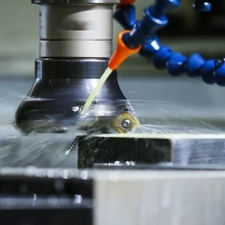 CNC milling machine producing a precision-machined aluminium part at Karpas Engineering in Hertfordshire.