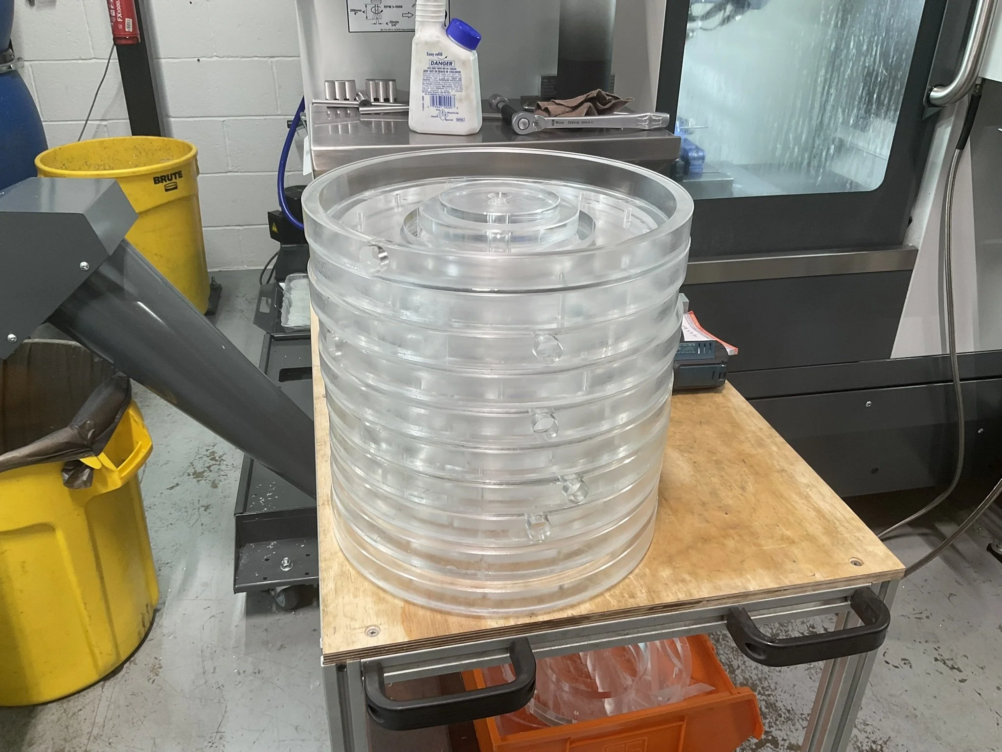 Large diameter clear acrylic light diffusers CNC machined using milling processes to achieve accurate profiles and clean finishes.