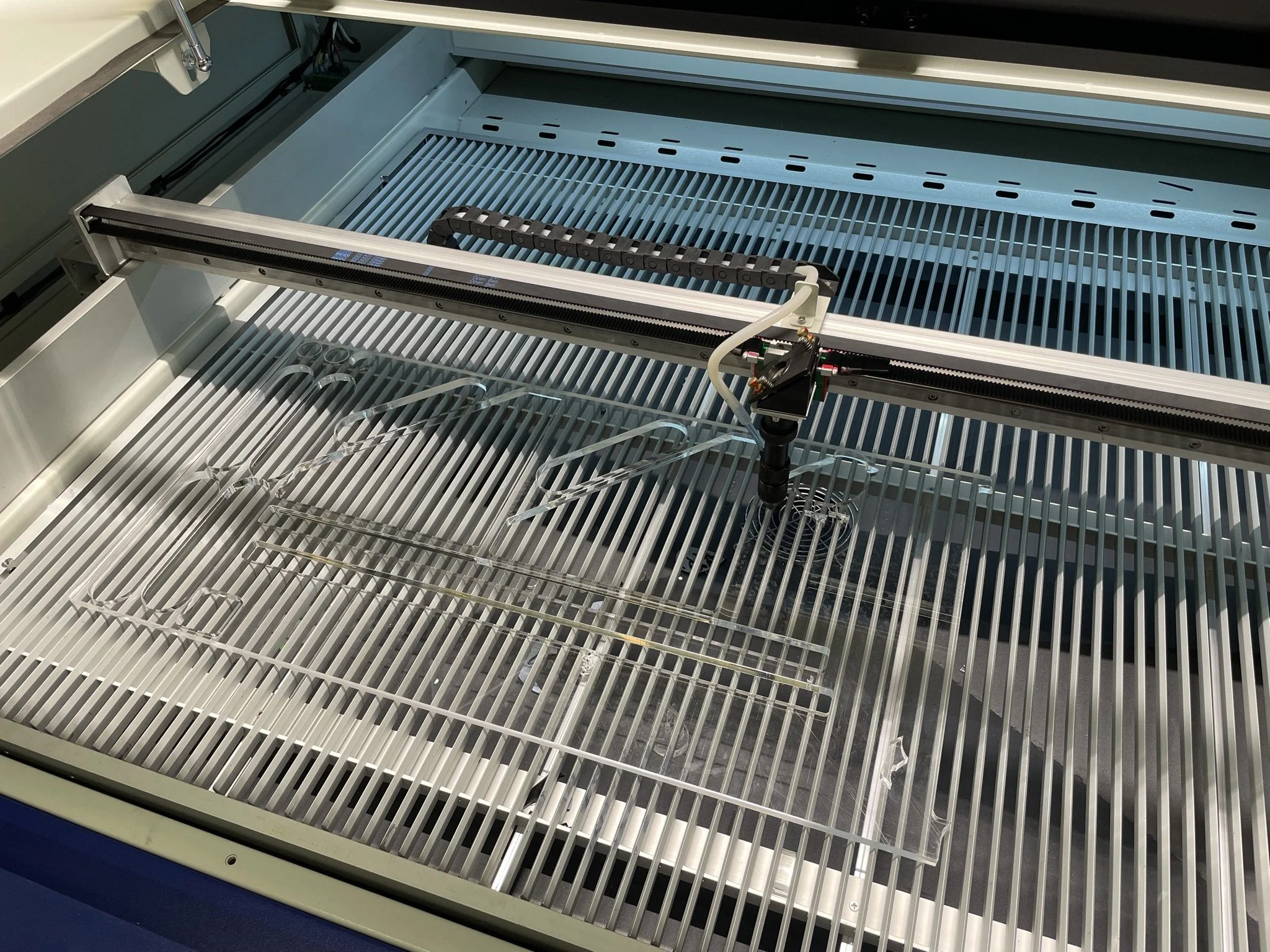 Acrylic panel being laser cut for enclosures and development fixtures.