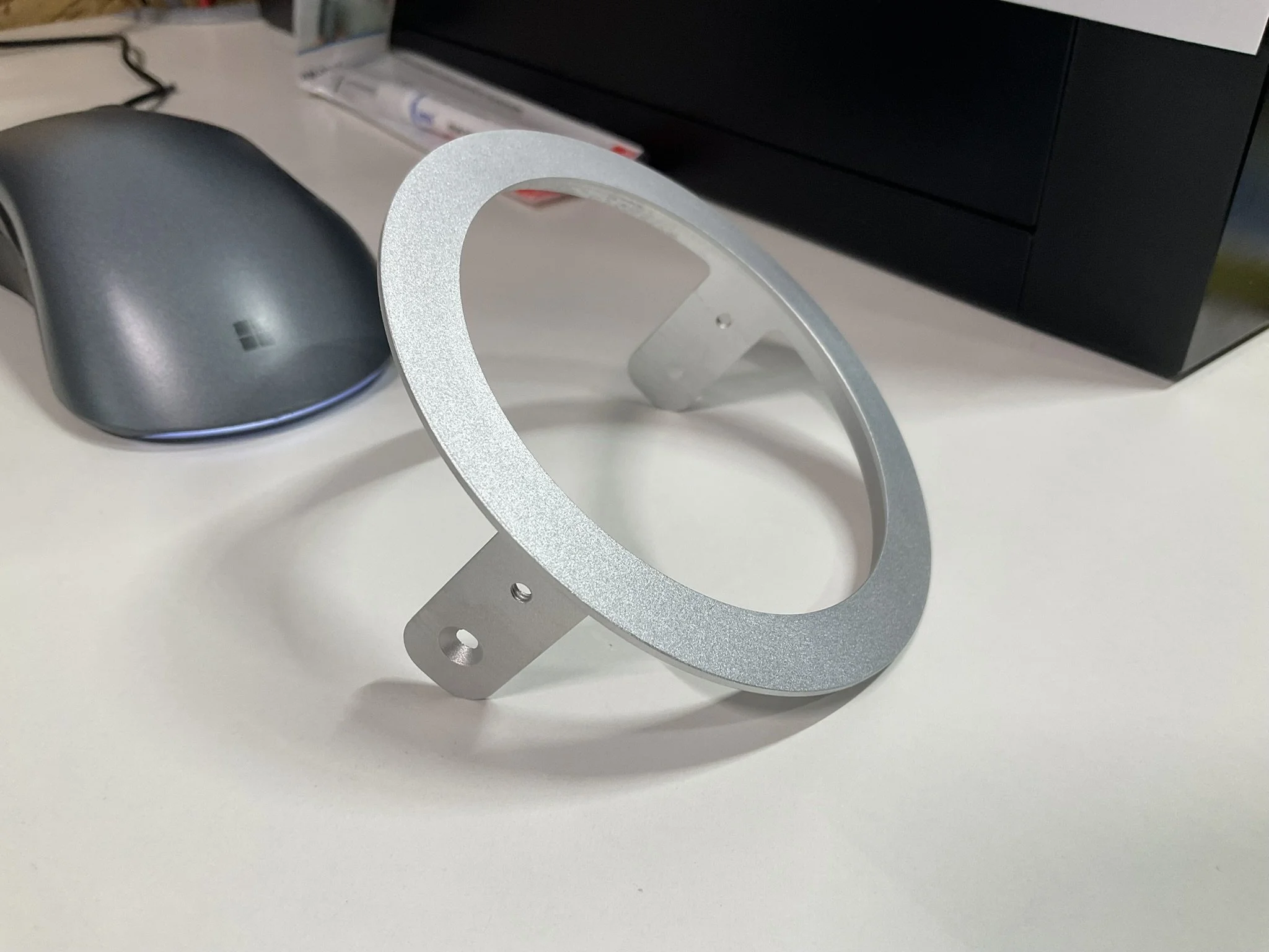 Thin machined light bezel with a clean edge finish, ready for assembly.