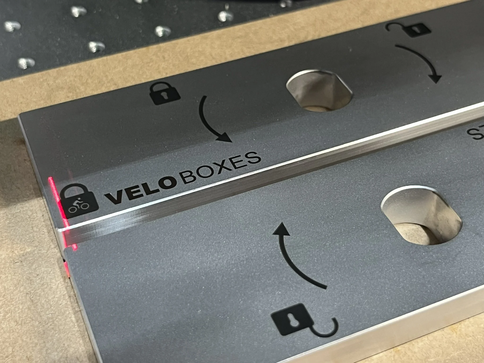 Aluminium bike lock being laser etched with branding and markings.