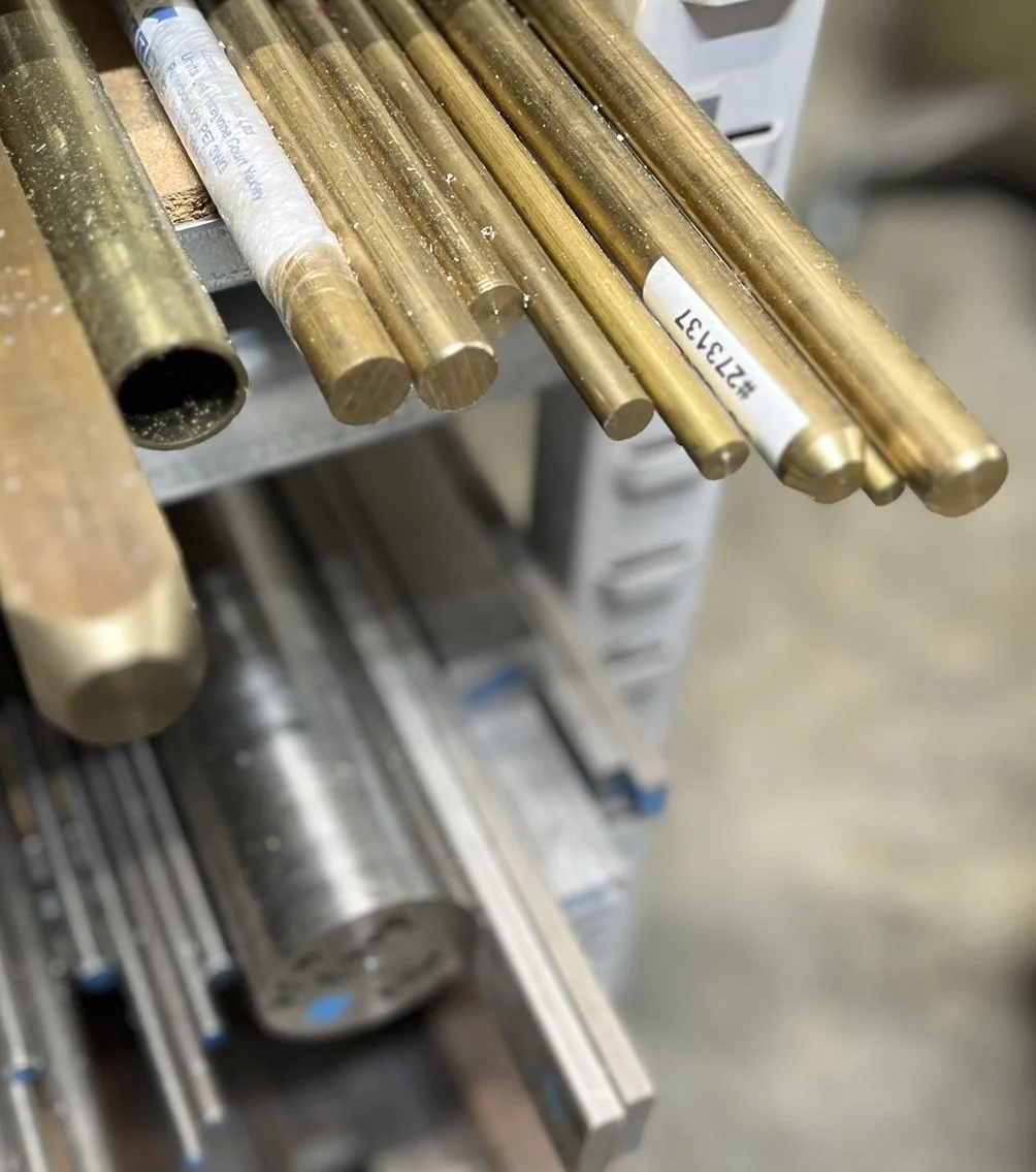 Shelf with aluminium, steel and plastic stock material for CNC machining.