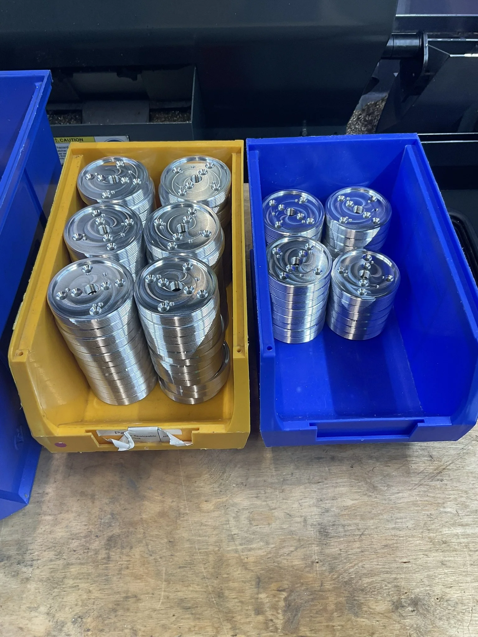 Batch of CNC-milled round parts after machining.