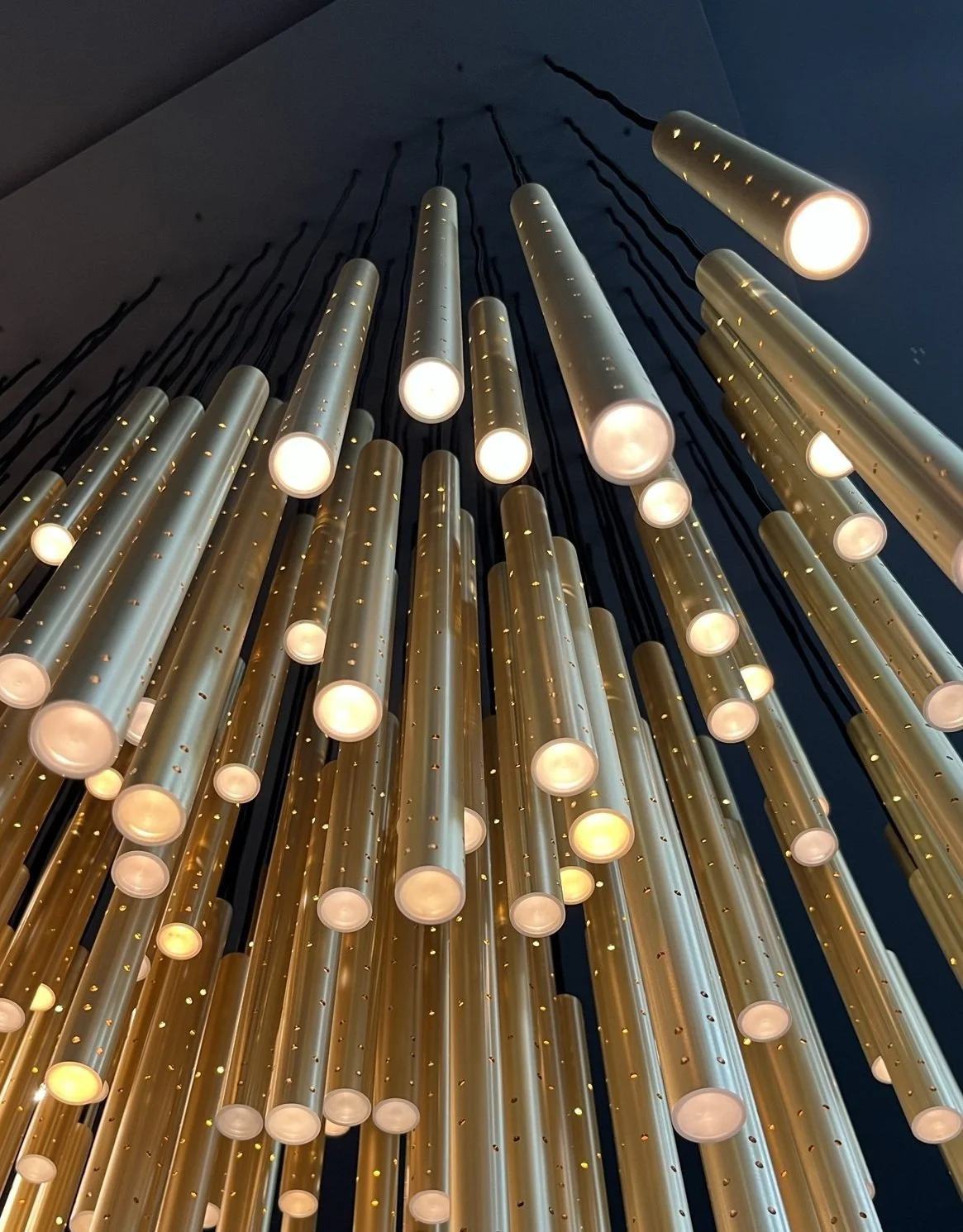 Custom architectural light fixture with precision-machined metal housing for interior installation.